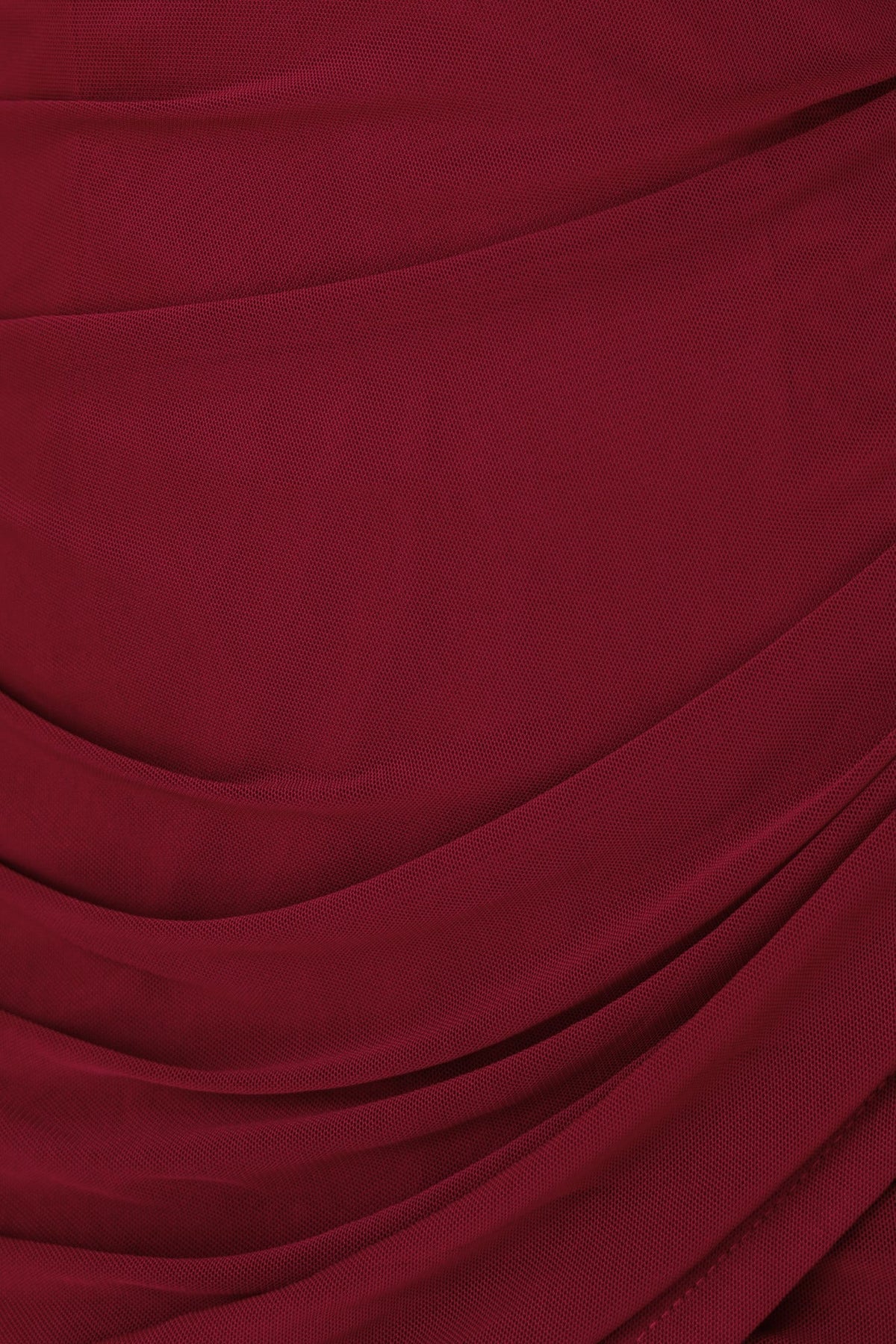Textured deep burgundy fabric featuring elegant draping, perfect for stylish dress designs.