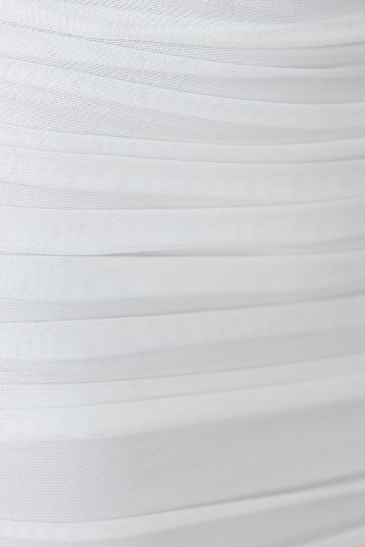 Close-up of the ruching detail on the Tammie Dress in white, showcasing its textured mesh material.