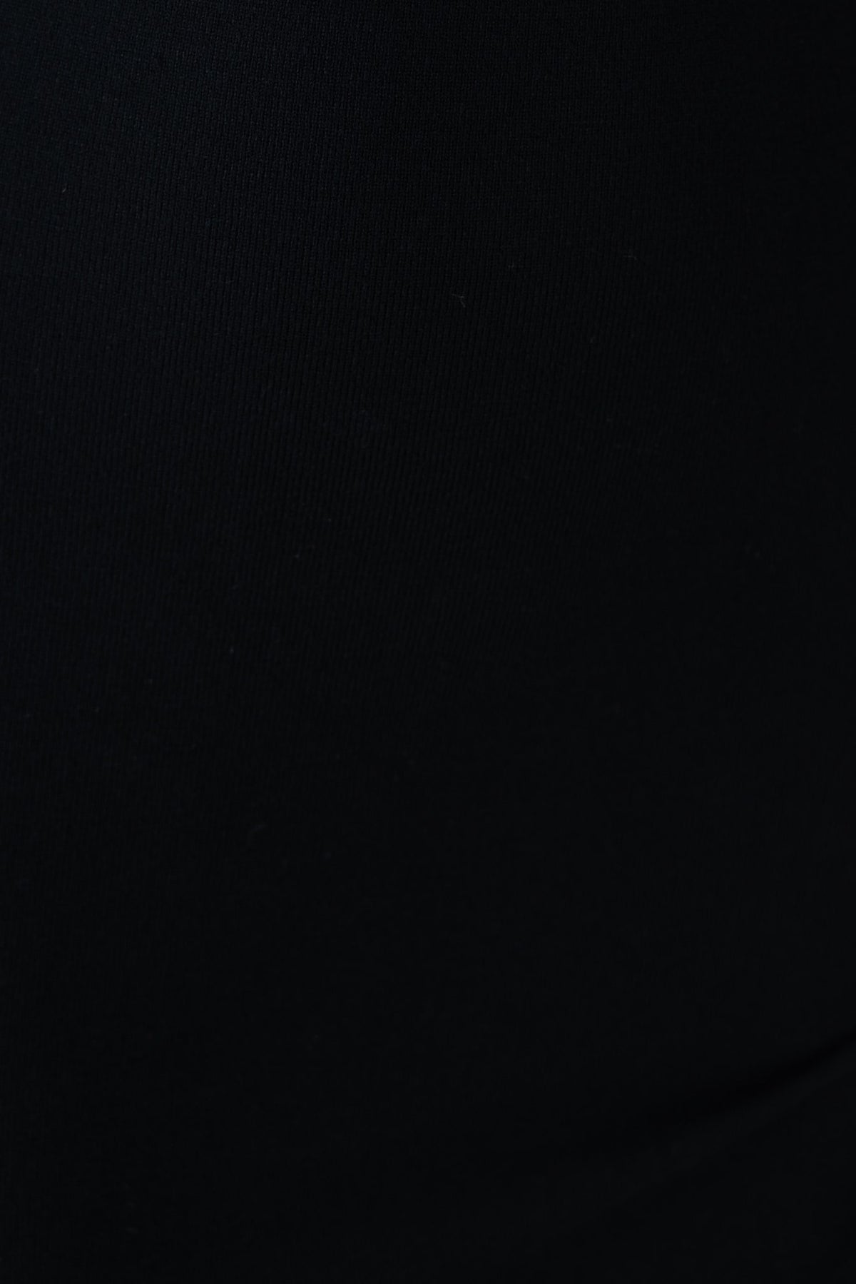 Close-up of black ribbed fabric showcasing the stretch and texture of the Dulce Midi Dress.