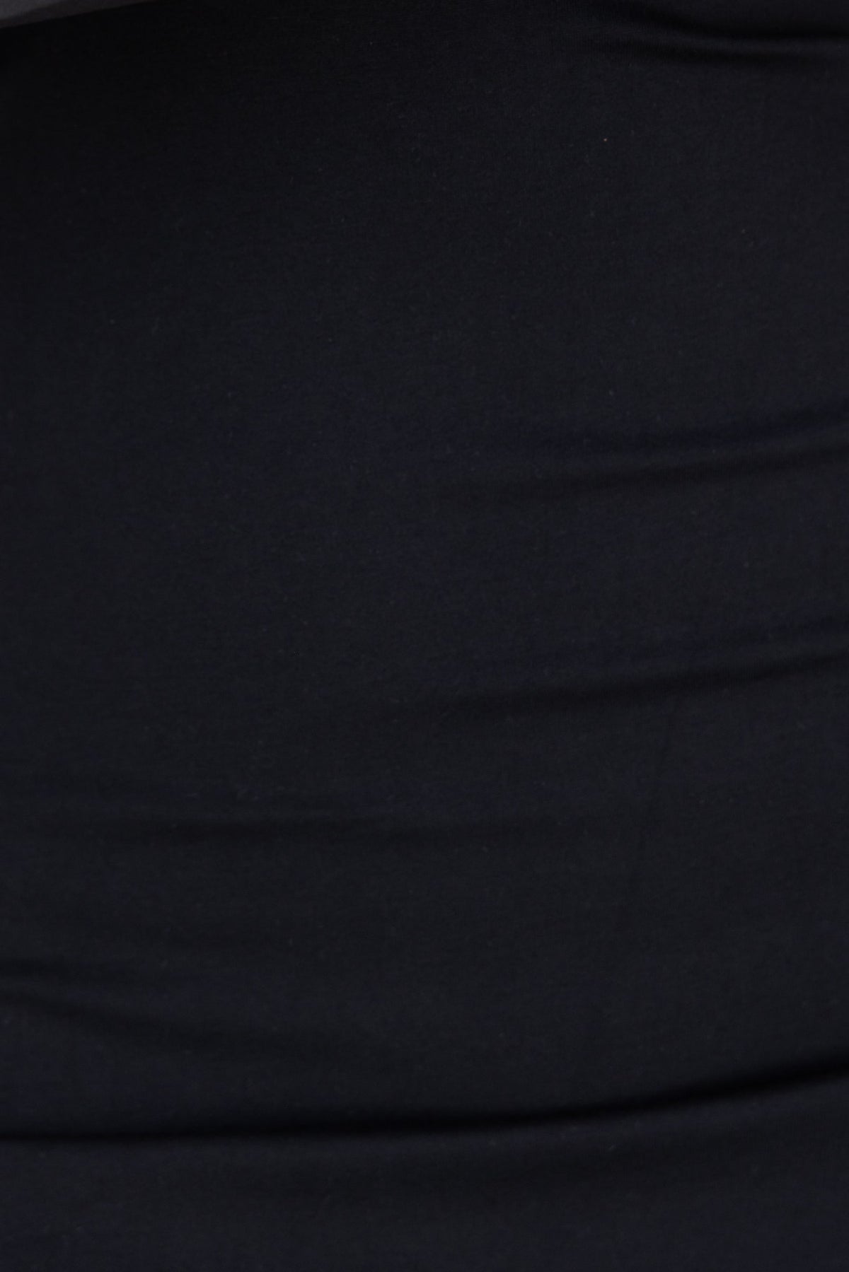 Close-up of black fabric, showcasing stretch material and texture of the Sabre Dress.