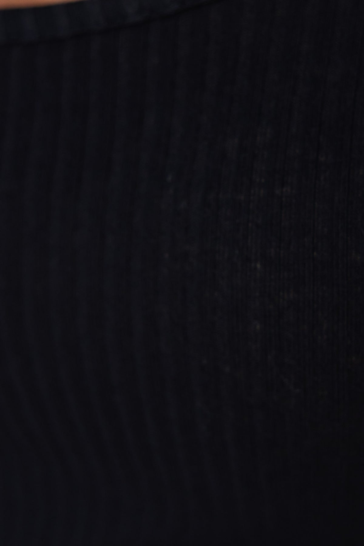 Close-up of black ribbed material showcasing the texture of a Claudia bodysuit.