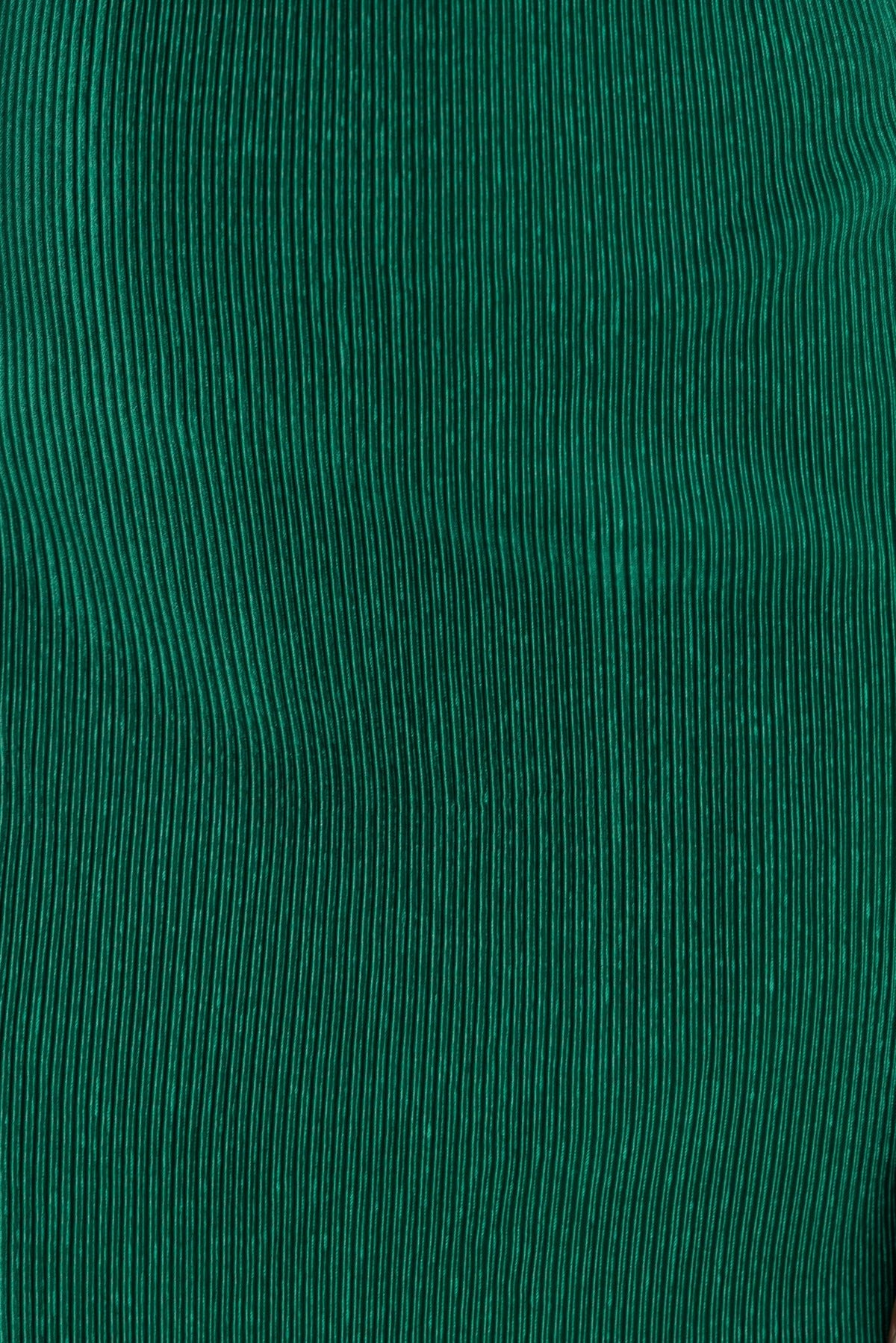 Green accordion pleat fabric detail showcasing textured ribbing for a stylish midi dress look.