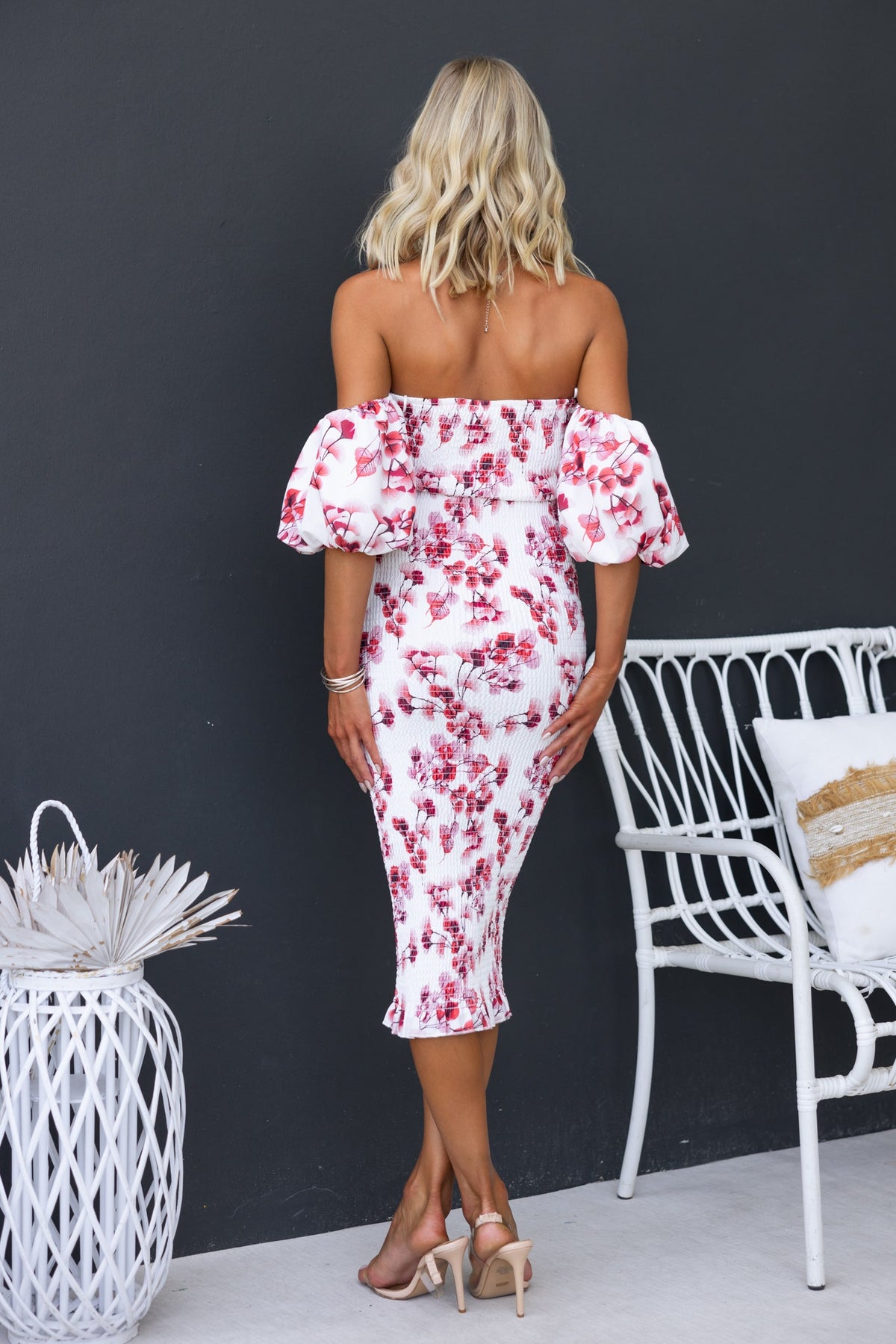 Back view of Gwenna Midi Dress, a floral off-shoulder bodycon dress with elastic fittings and fitted silhouette.
