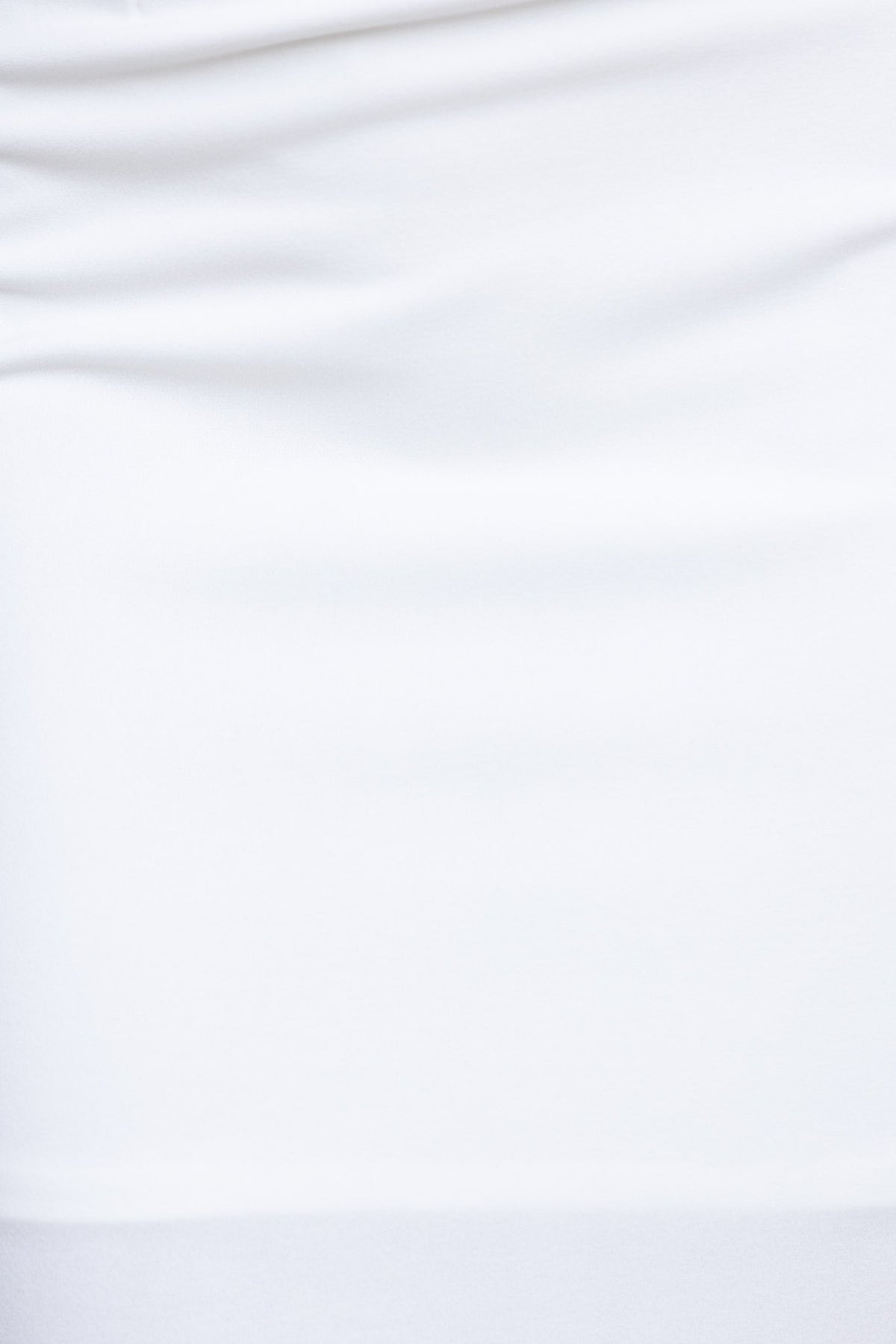 Close-up of soft, white fabric texture from a garment, showcasing smooth polyester material.