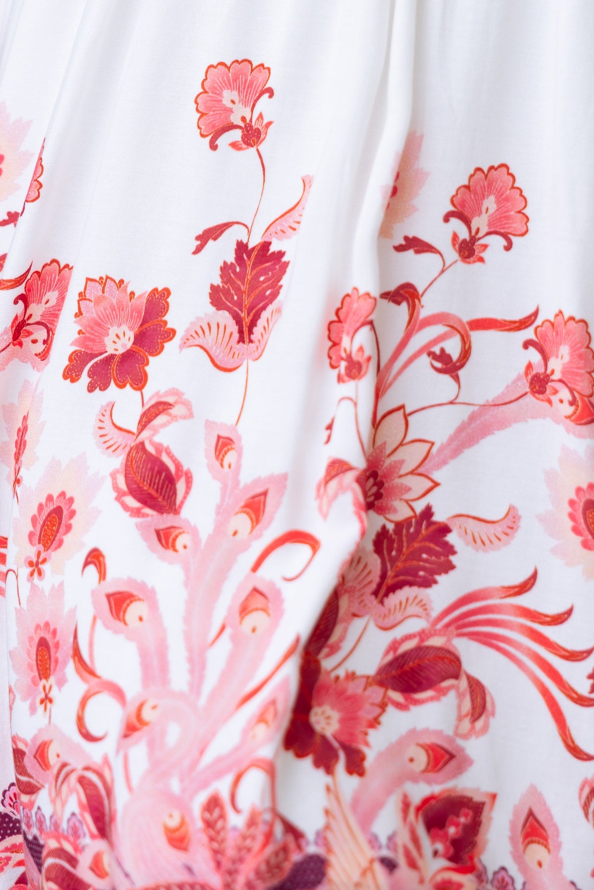 Close-up of the floral pattern on the Lenika Dress, featuring vibrant shades of pink and red designs.