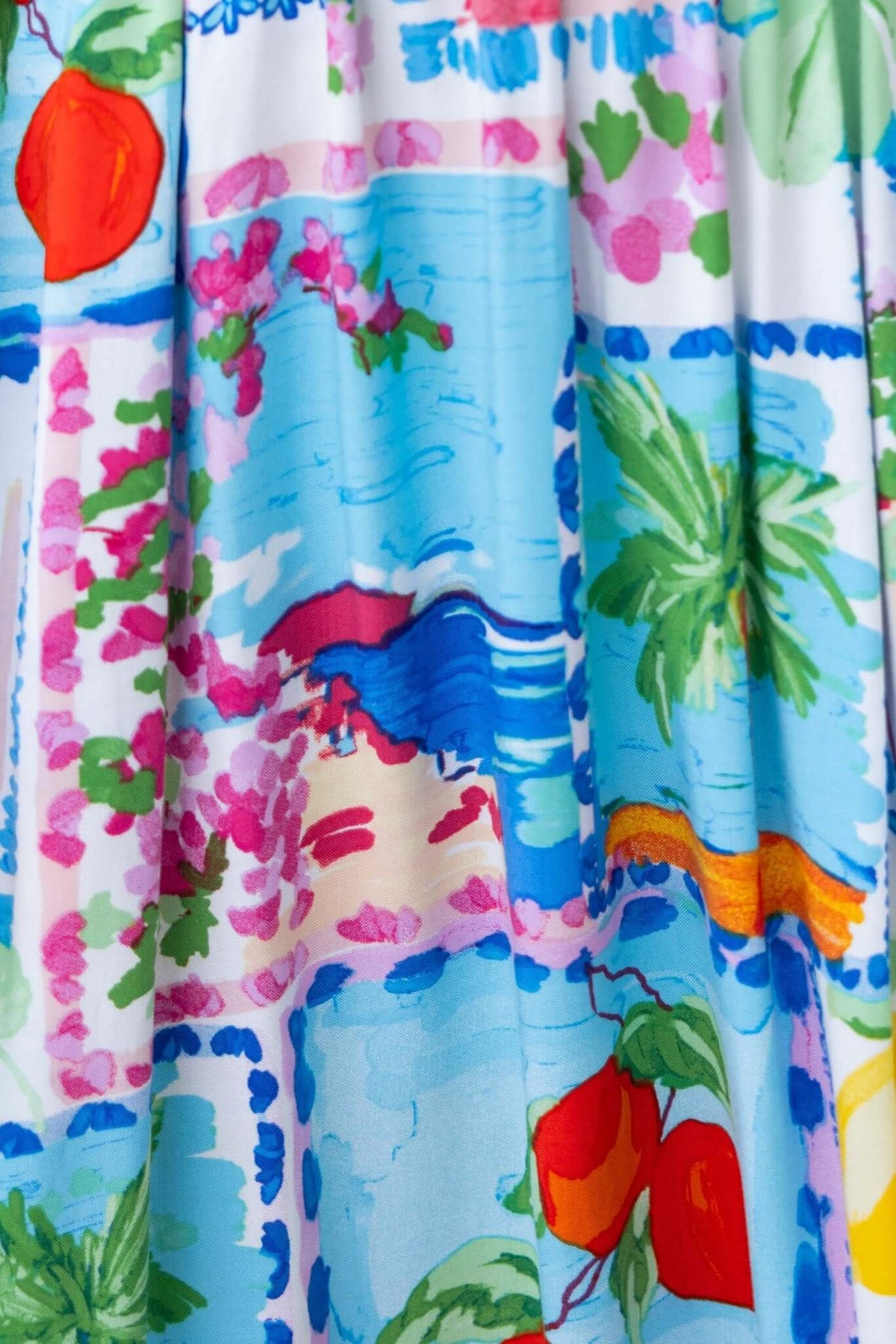 Colorful floral and beach-themed print on the fabric of a Dewberry Maxi Dress.