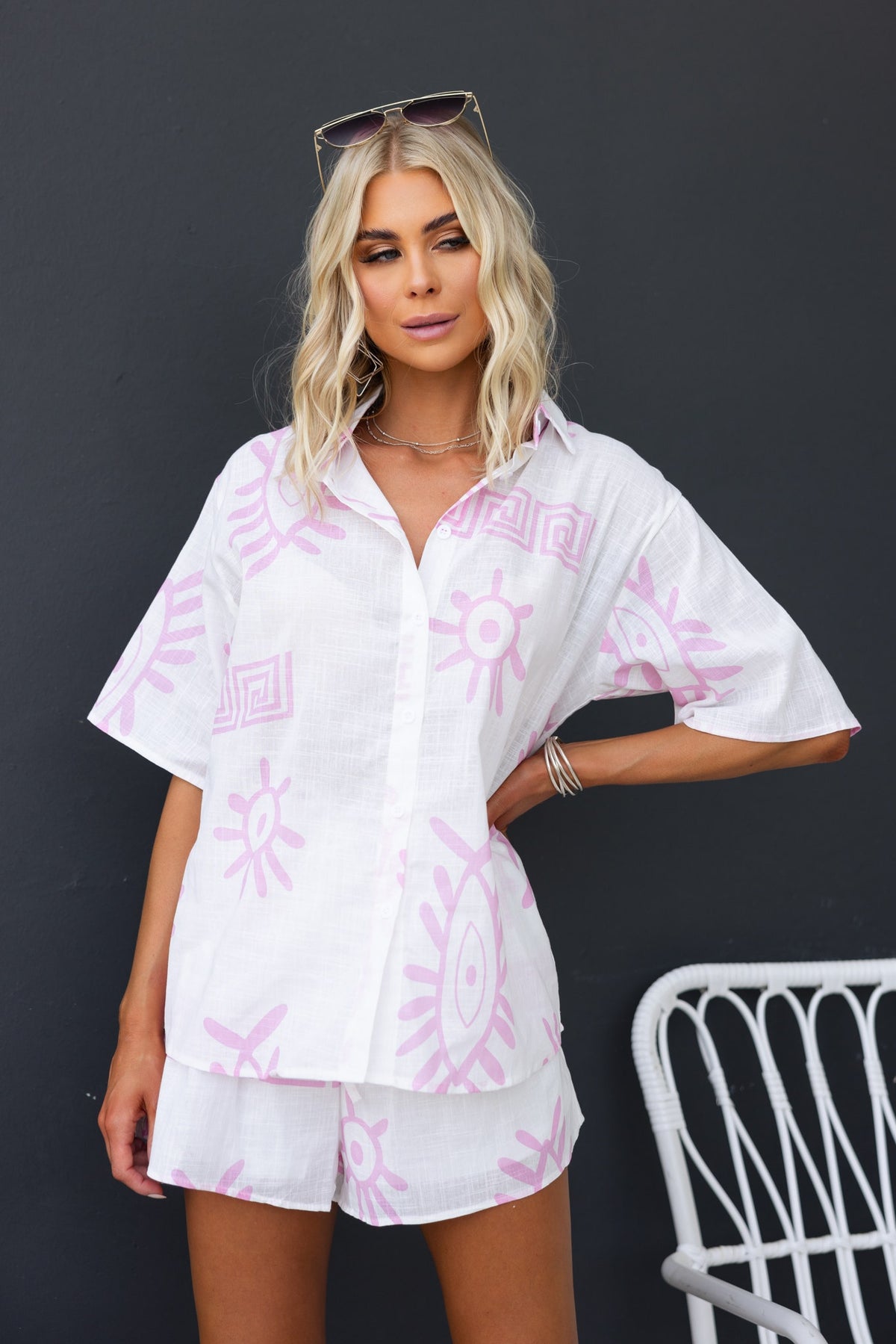 Model wearing Tamba Set featuring a pink patterned button-up shirt and matching shorts, perfect for summer styling.