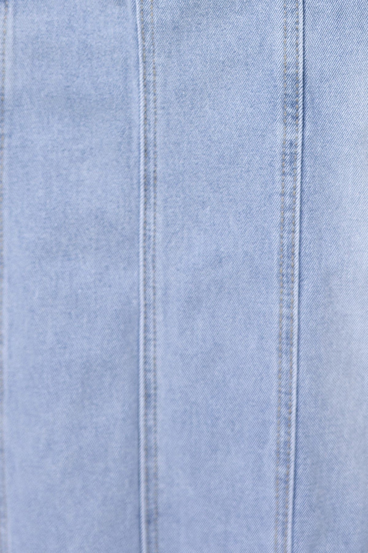 Close-up view of light blue denim fabric with visible stitching for Azra Denim Midi Skirt.