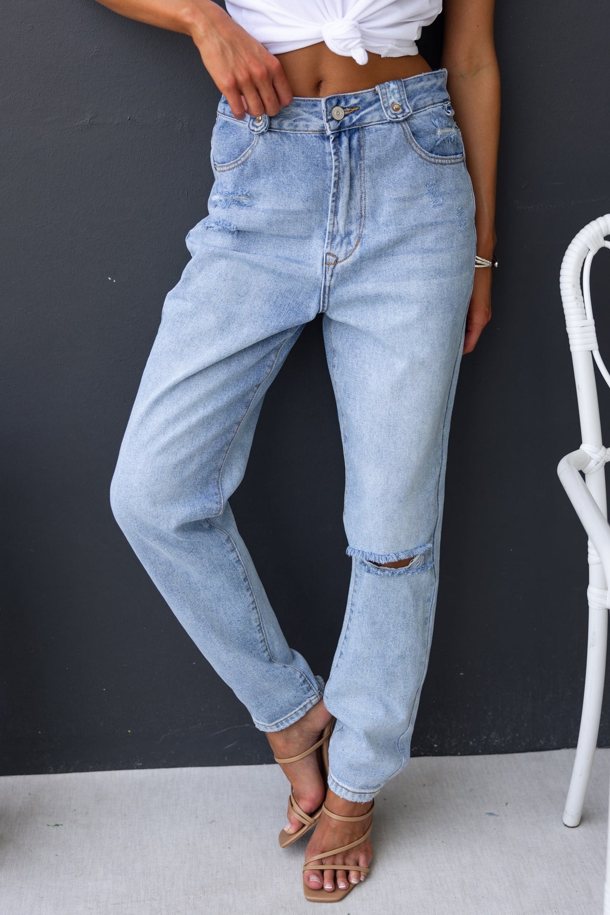 Model wearing Kaylie Jeans featuring a mid-high waist, distressed detail, and a boyfriend style fit.
