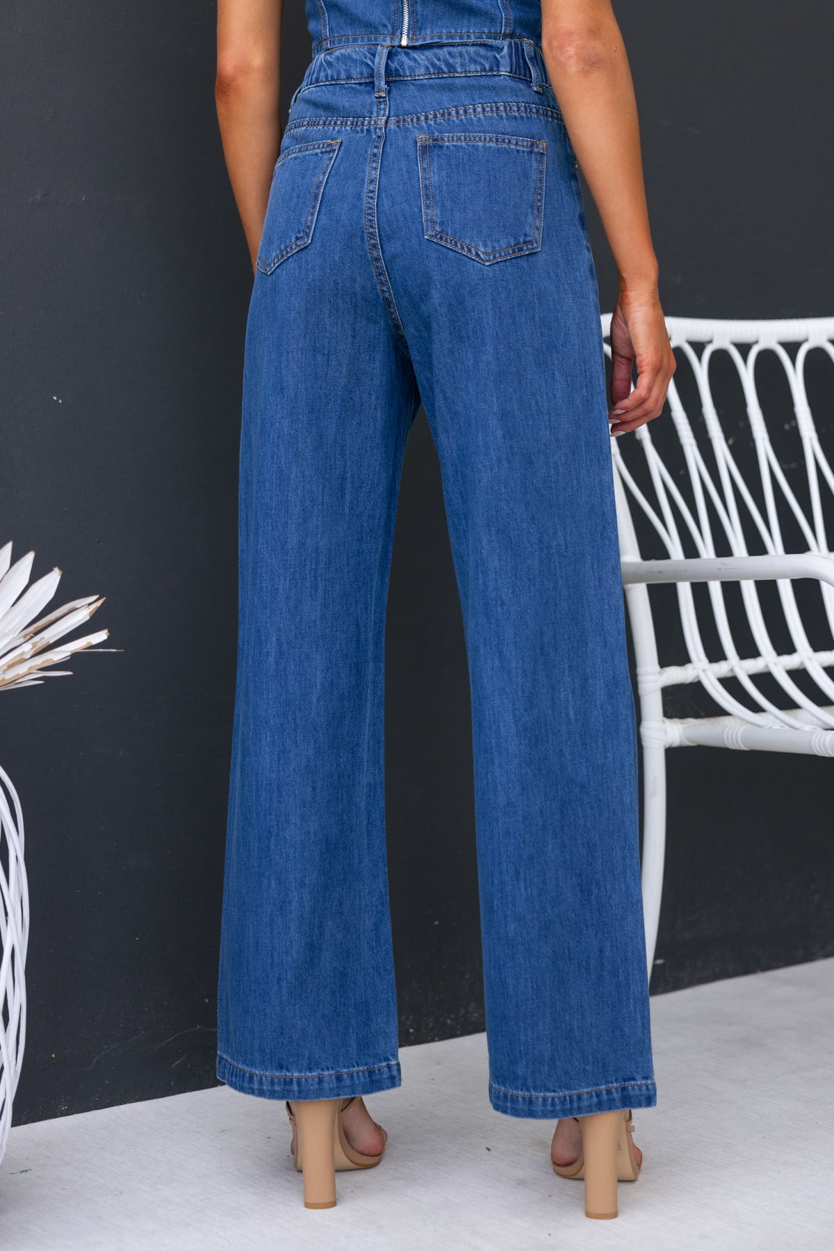Model wearing Sierra Jeans with mid-high waist and wide leg fit, showcasing back pockets and denim fabric.