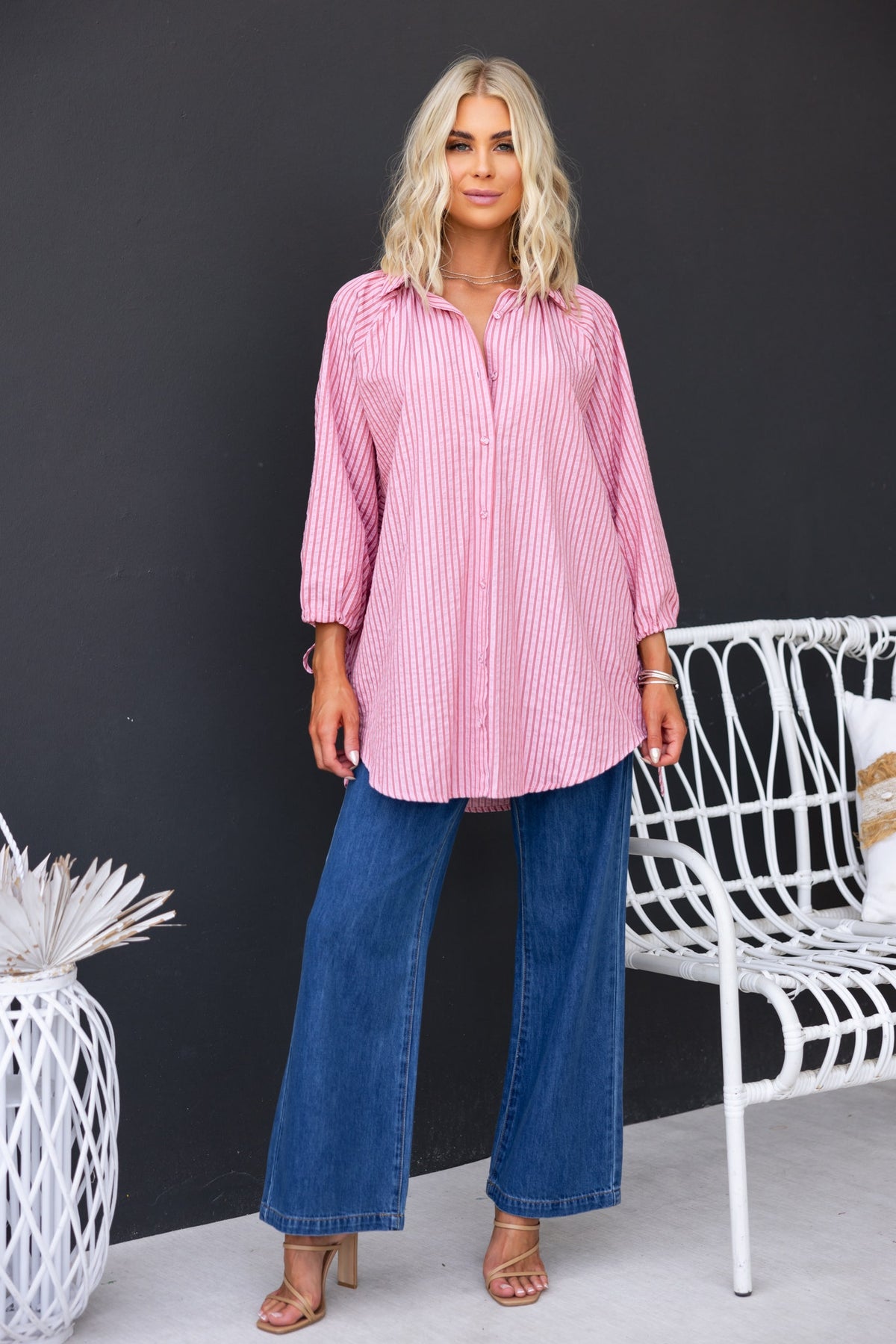 Model wearing a striped Sorbet shirt with button-up front, paired with wide-leg jeans and stylish sandals.