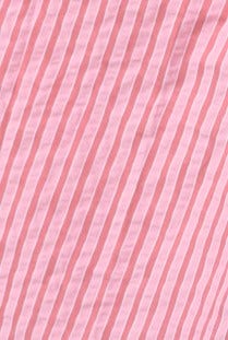 Close-up view of textured pink fabric with vertical stripes, ideal for the Sorbet Shirt, made from cotton and polyester.