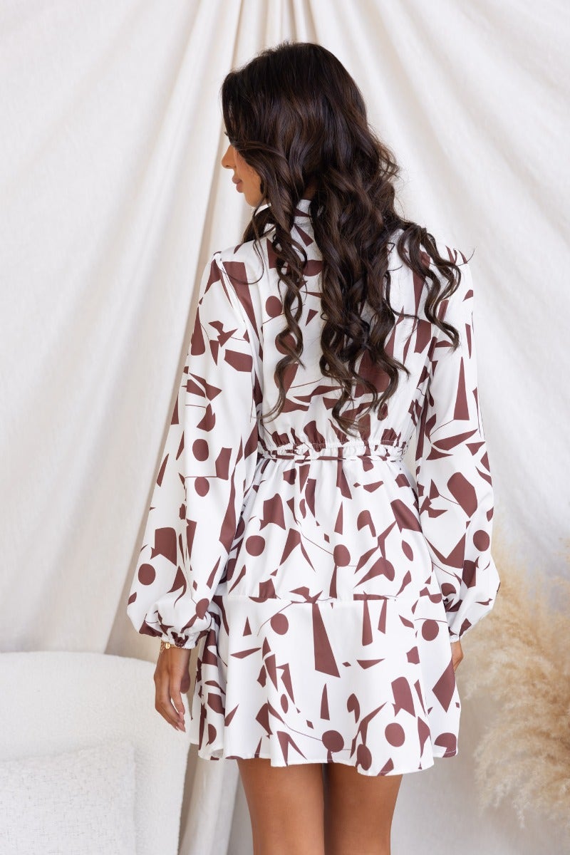 Back view of the Eleyna multi-colour print dress featuring a high neckline and elastic details.