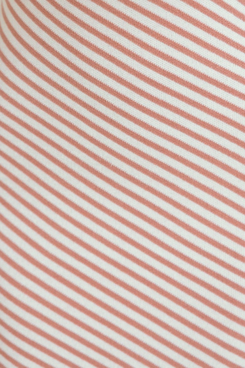 Close-up of ribbed knit fabric in coral and white striped pattern, ideal for a stylish midi dress.