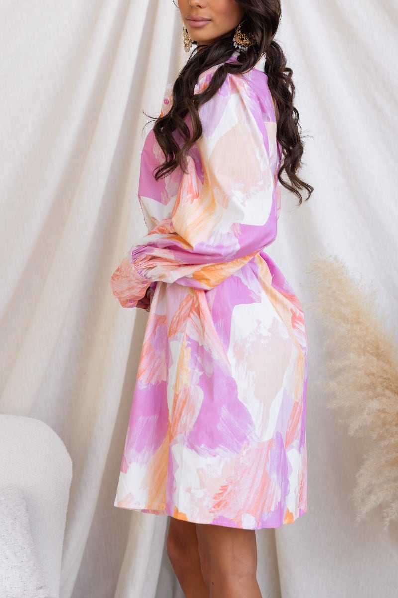 Wrenley Dress in pastel pink and orange hues, featuring a collar and removable belt, showcased on a model.