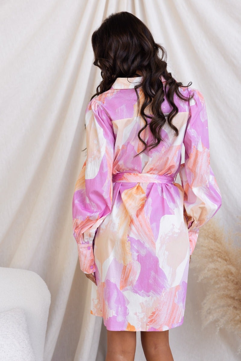 Back view of Wrenley dress with colorful floral print, featuring a collar and removable fabric belt.