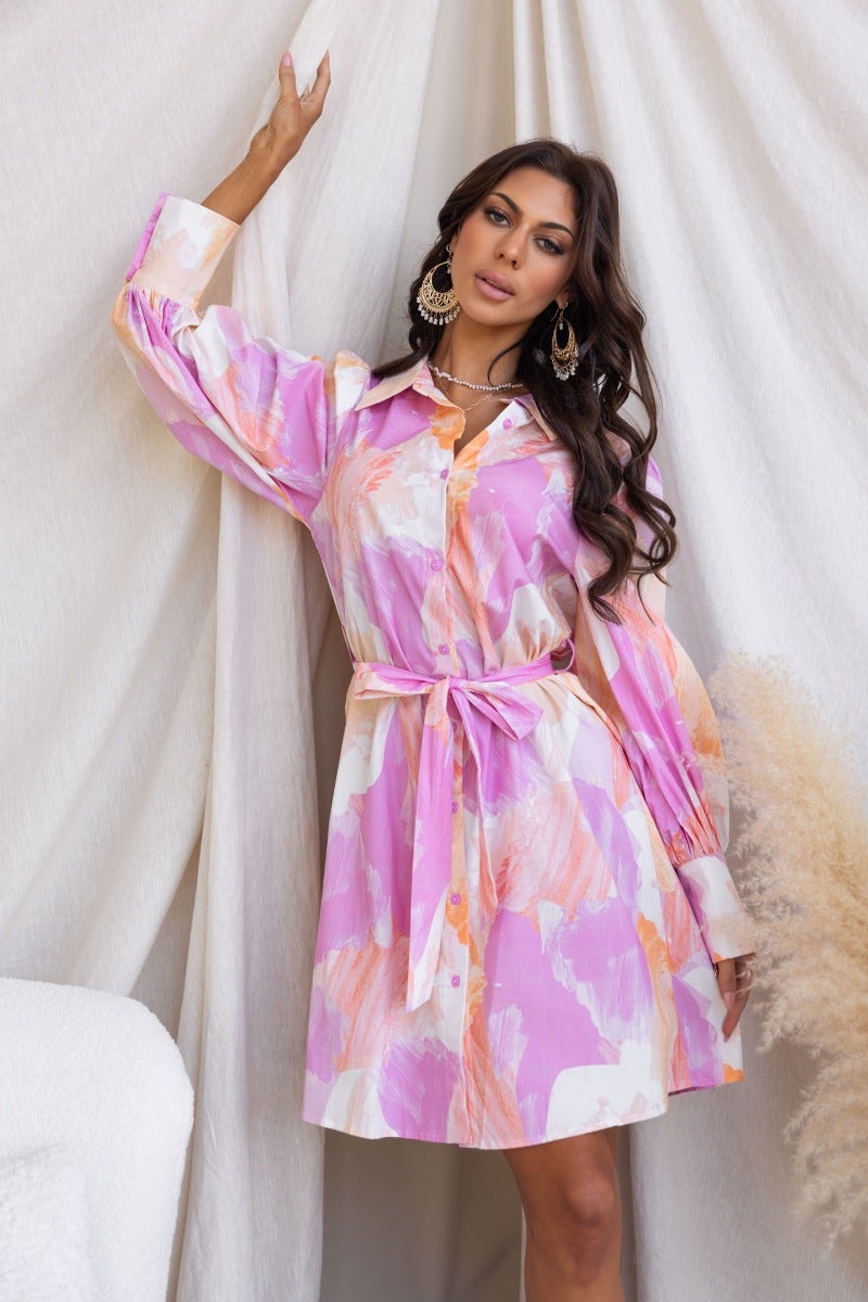 Model wearing the Wrenley Dress in pink and orange with a collar and removable belt, showcasing a stylish look.