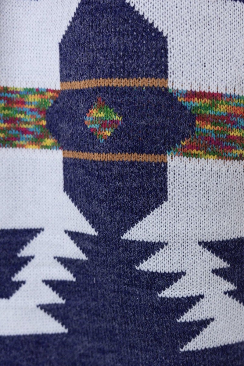 Close-up of Lazuli Cardigan's navy print featuring geometric patterns and colorful accents.