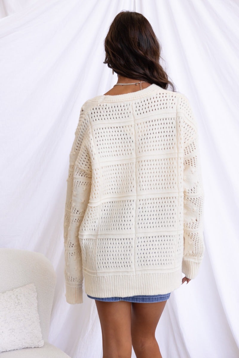 Back view of Azaria Cardigan, a textured knit V-neck cardigan with a relaxed fit and slight open weave.