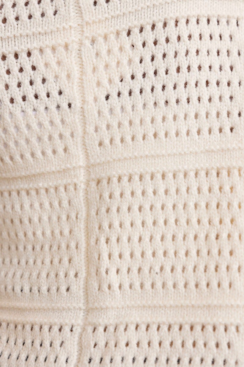 Close-up of textured open weave fabric of Azaria Cardigan in cream color, showcasing its lightweight and breathable design.