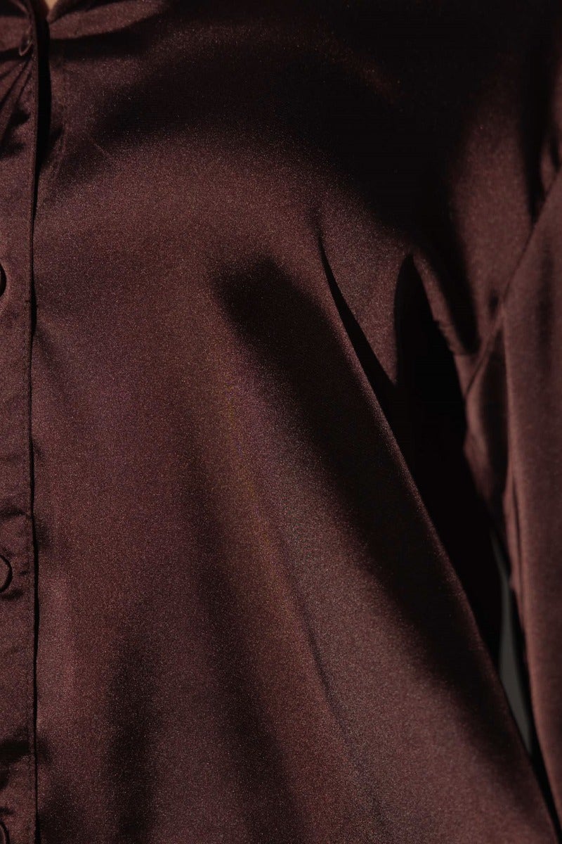 Close-up of Daina Satin Shirt showing rich brown fabric and button-up detail.