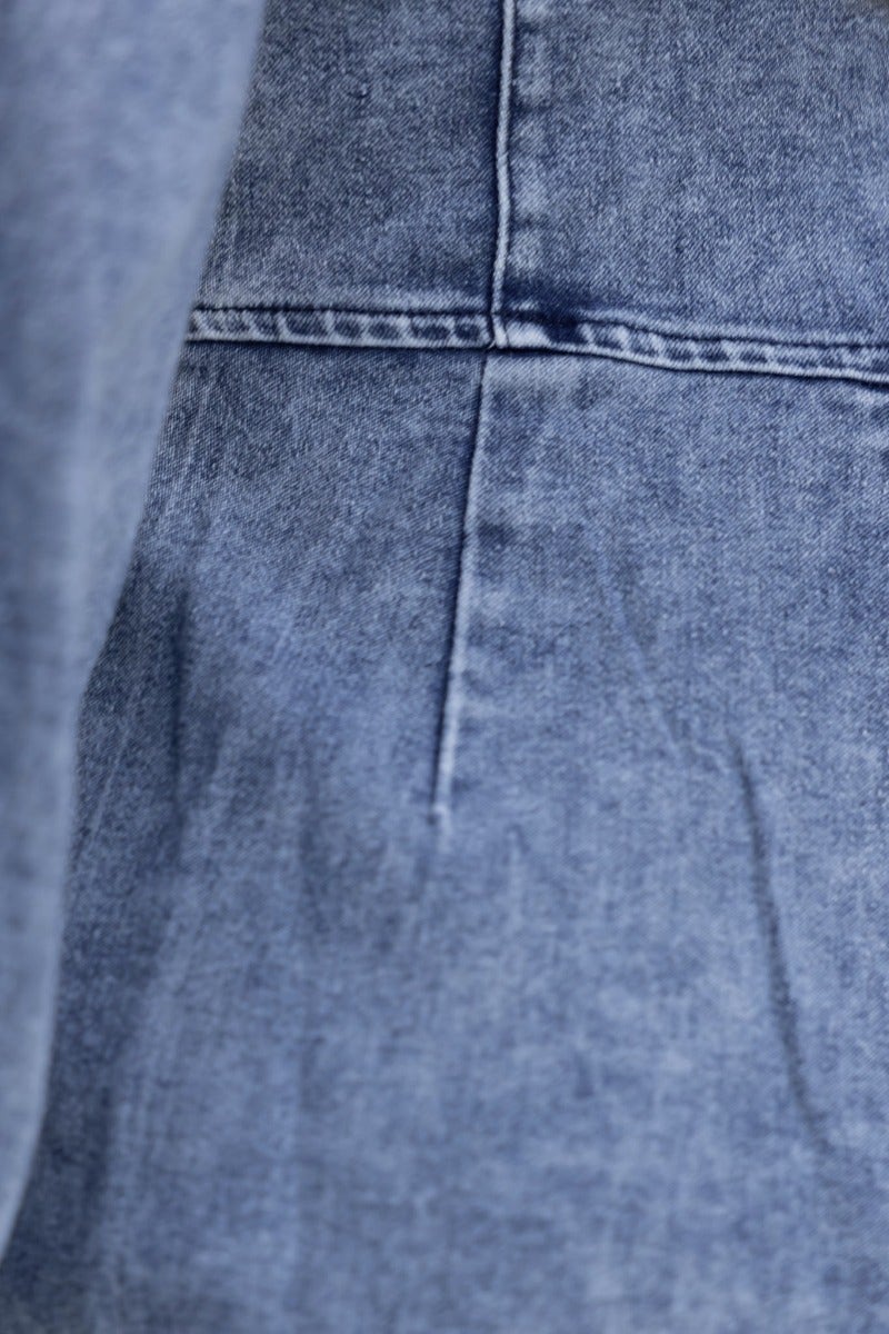 Close-up of denim texture on Nova Denim Playsuit showcasing stitching and fabric details.