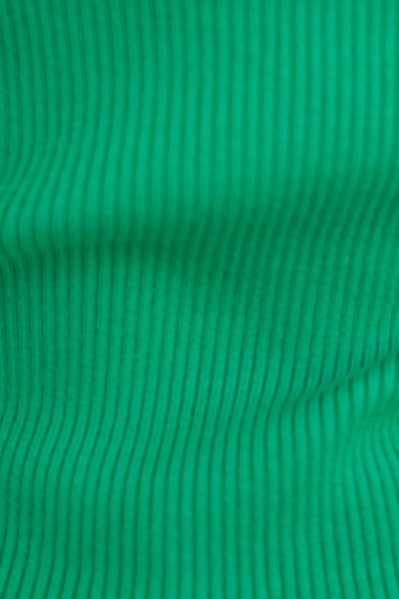 Close-up of ribbed knit fabric in vibrant green, showcasing texture and stretch for the Inala Top.