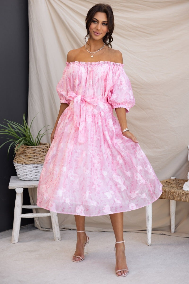 Pink embossed print midi dress with elastic neckline and removable belt, styled with strappy heels.