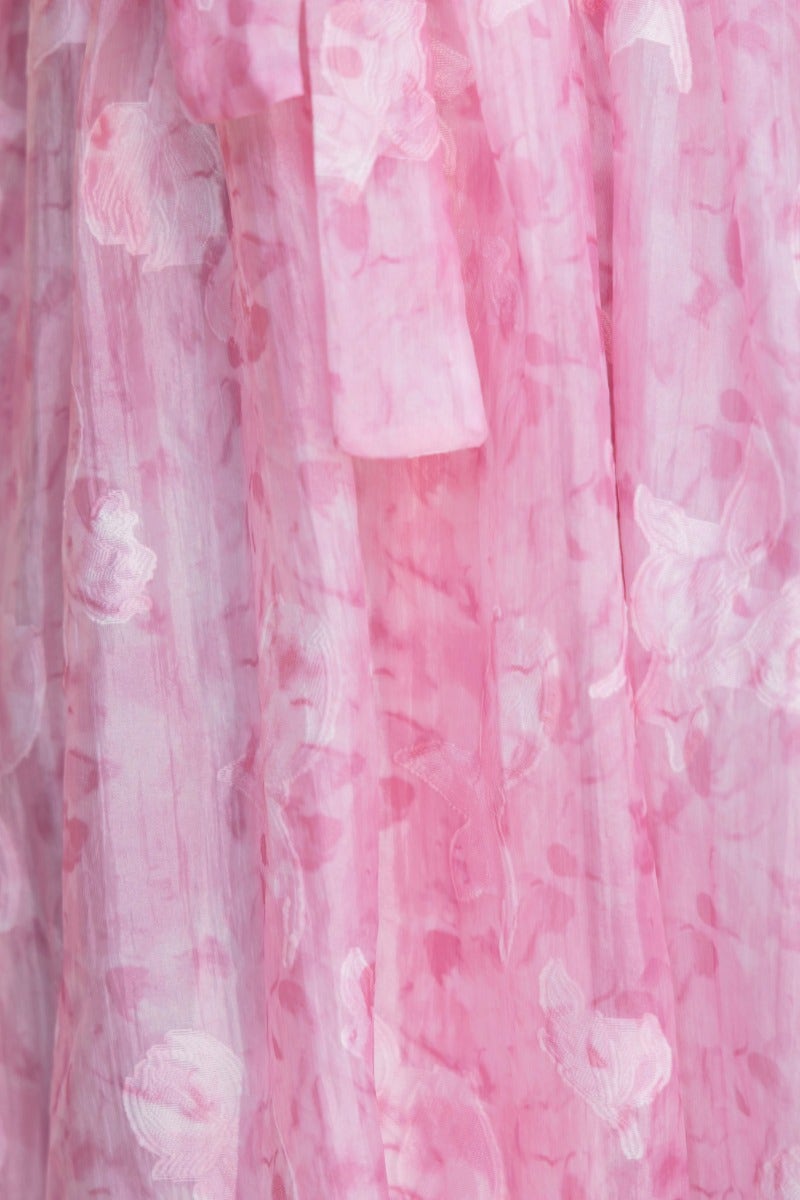 Close-up of the Jenay Midi Dress featuring an embossed floral print in soft pink hues.