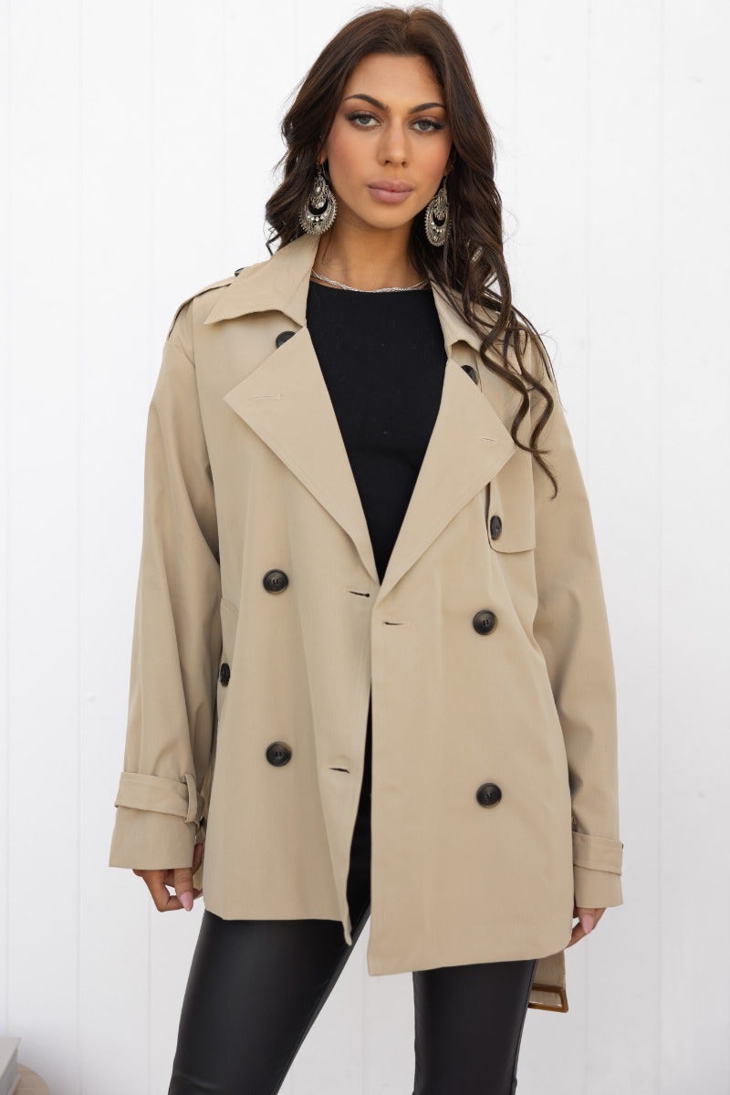 Andie Jacket in beige with double-breasted buttons, collar, and removable belt, model wearing oversized fit.