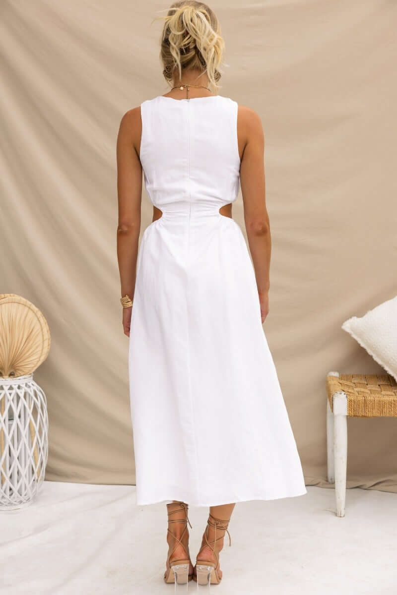 Back view of Rozita Midi Dress featuring a round neckline, cut-out sides, and slit detail. Perfect for summer outings.