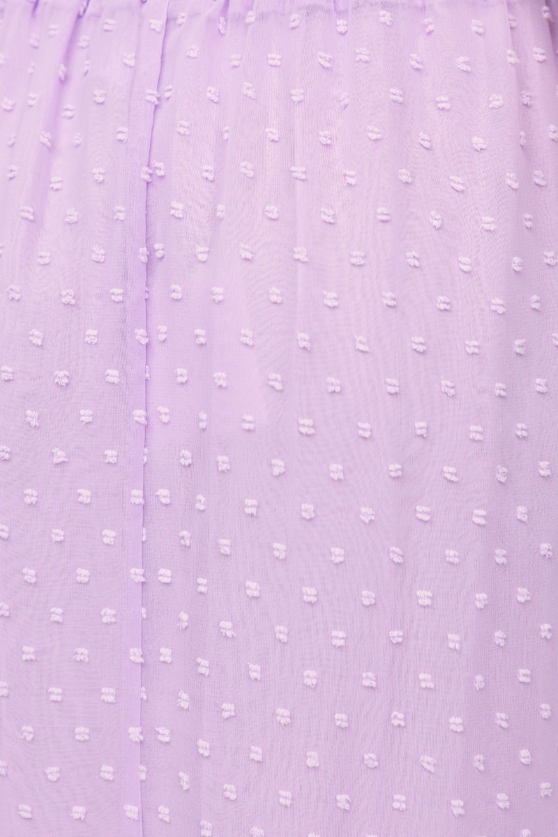 Close-up of textured lavender fabric with dotted pattern, showcasing delicate details for the Rosalia Top.
