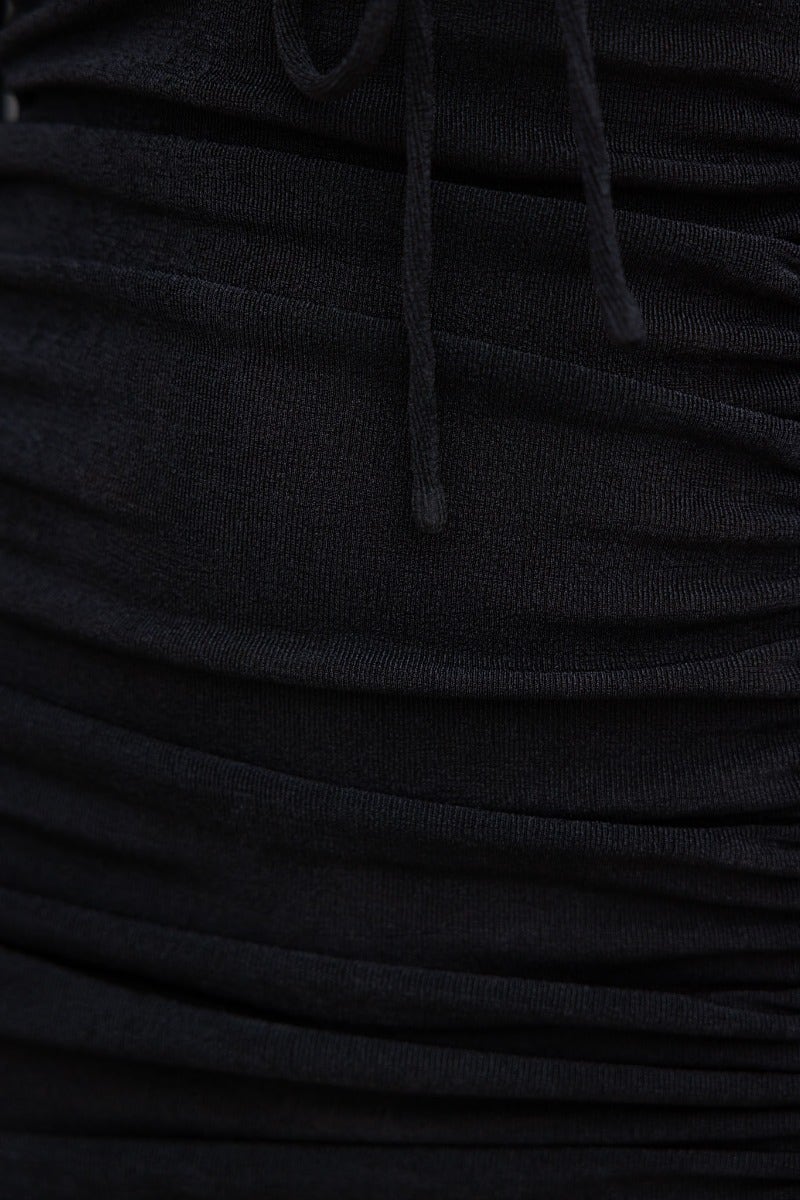 Close-up of the adjustable ruching and drawstring tie details on the black Panama Dress.