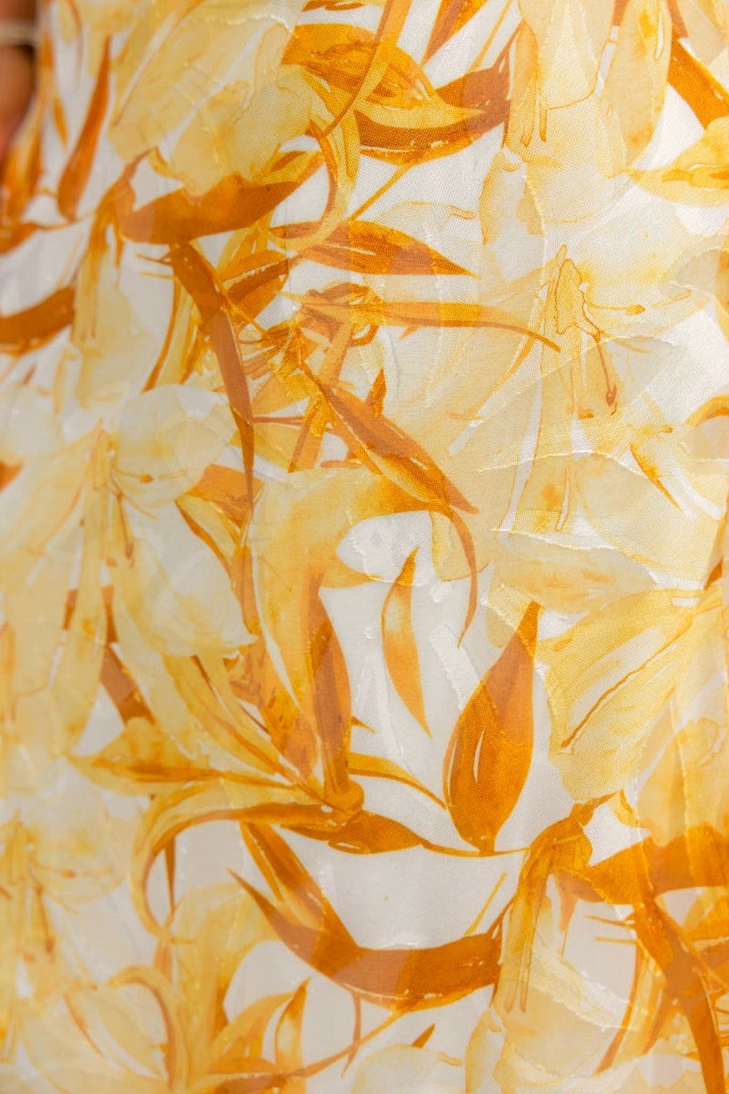 Close-up of floral print fabric featuring yellow and orange leaves suitable for a Samaya Maxi Dress.