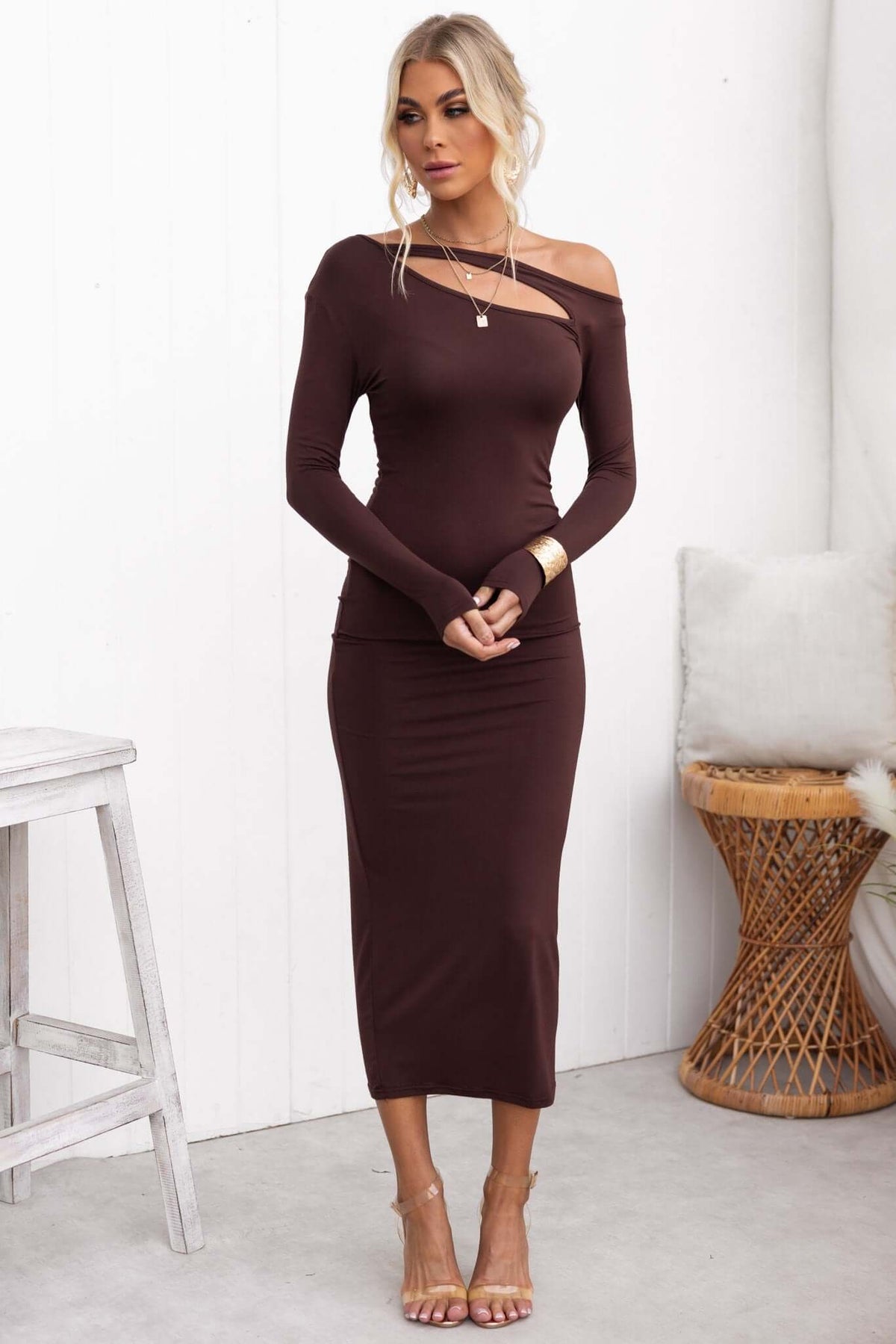 Alatri Maxi Dress in brown with cut-out neckline and long sleeves, styled with accessories, perfect for a chic, casual look.