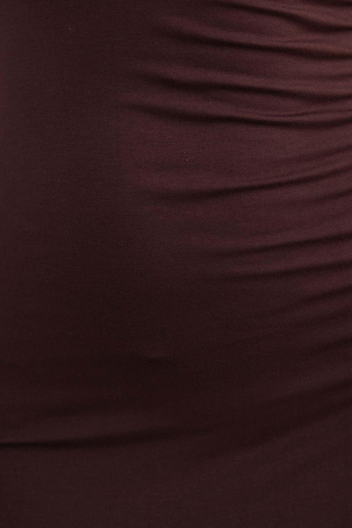 Close-up of soft, stretchy brown fabric with ruched texture, ideal for dresses and form-fitting clothing.