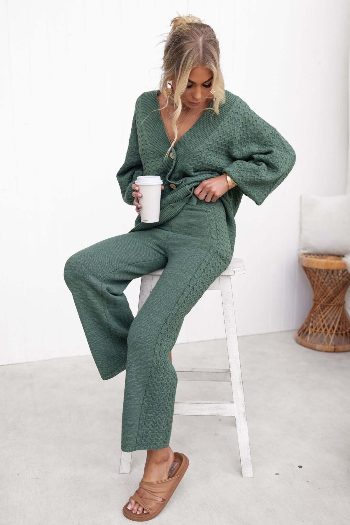 Woman in green Jesse Pants with elastic waistband, styled with a casual top, holding a coffee cup.