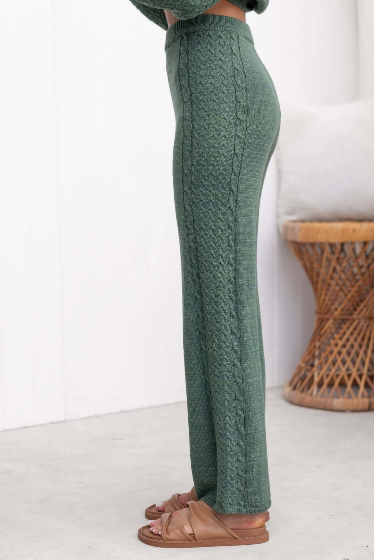 Side view of Jesse Pants in green, featuring a high waist, drop crotch style, and cable knit design.