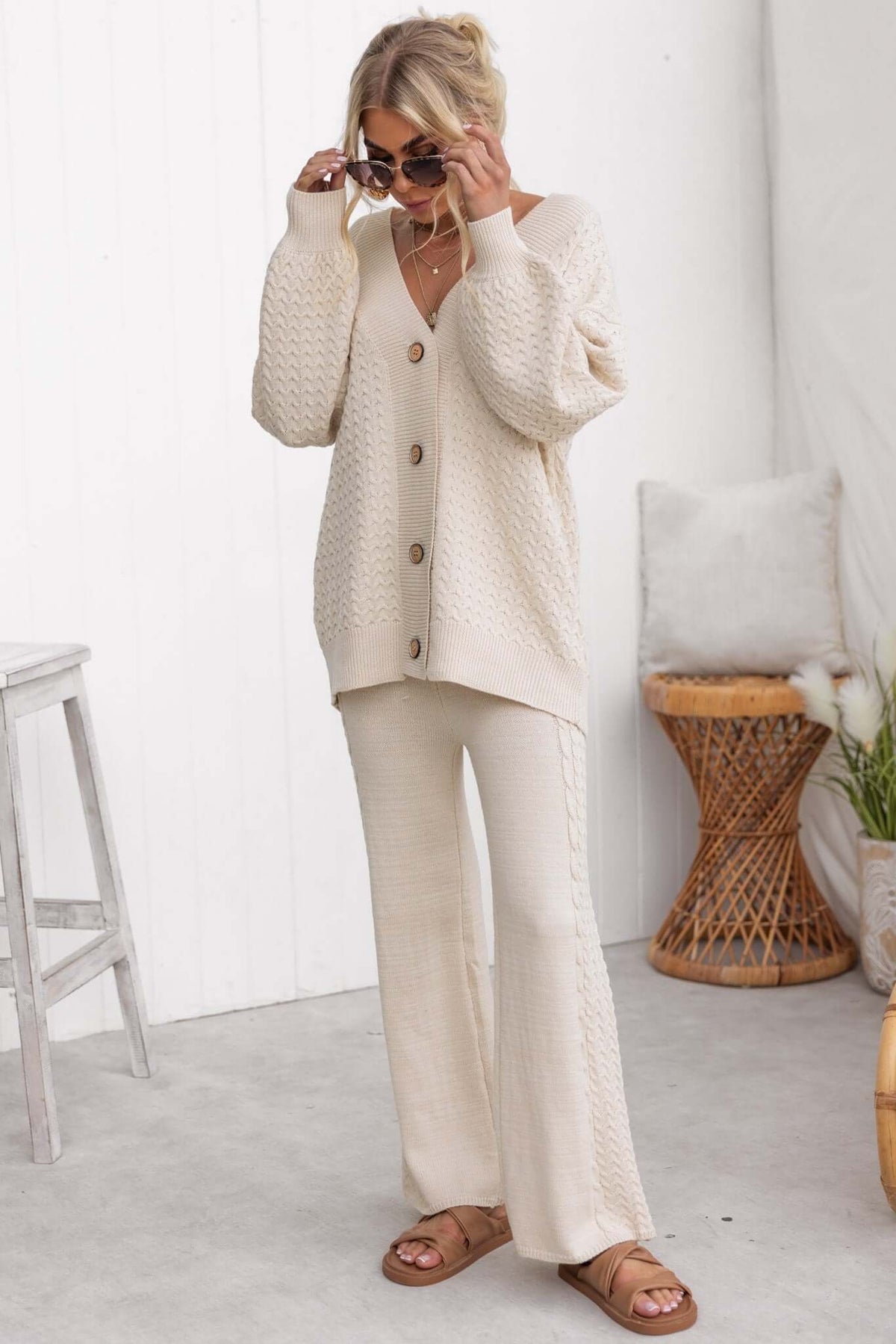 Model wearing beige knitted Jesse Pants with matching cardigan, showcasing a cozy and stylish outfit.