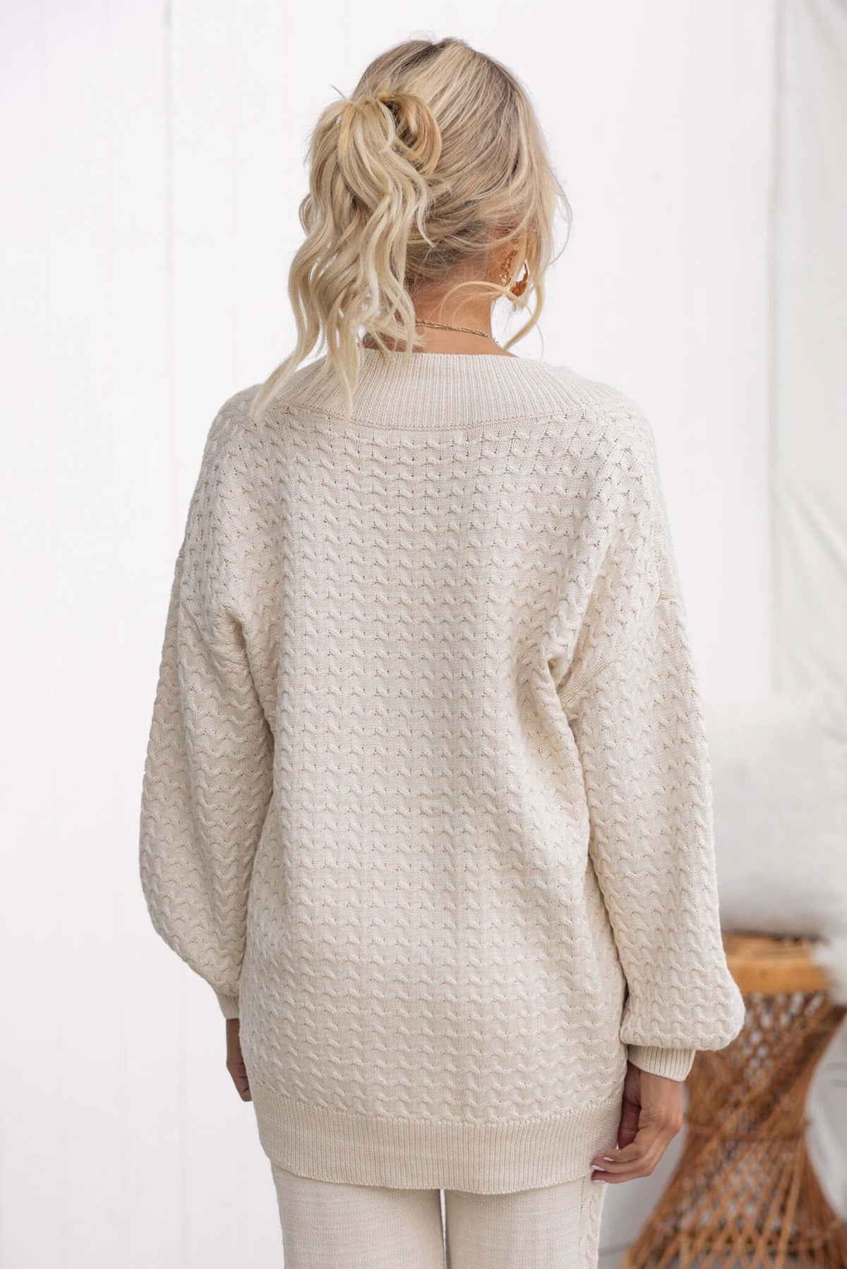 Back view of the Jesse Cardigan in cream, featuring a relaxed fit, knitted texture, and stylish balloon sleeves.