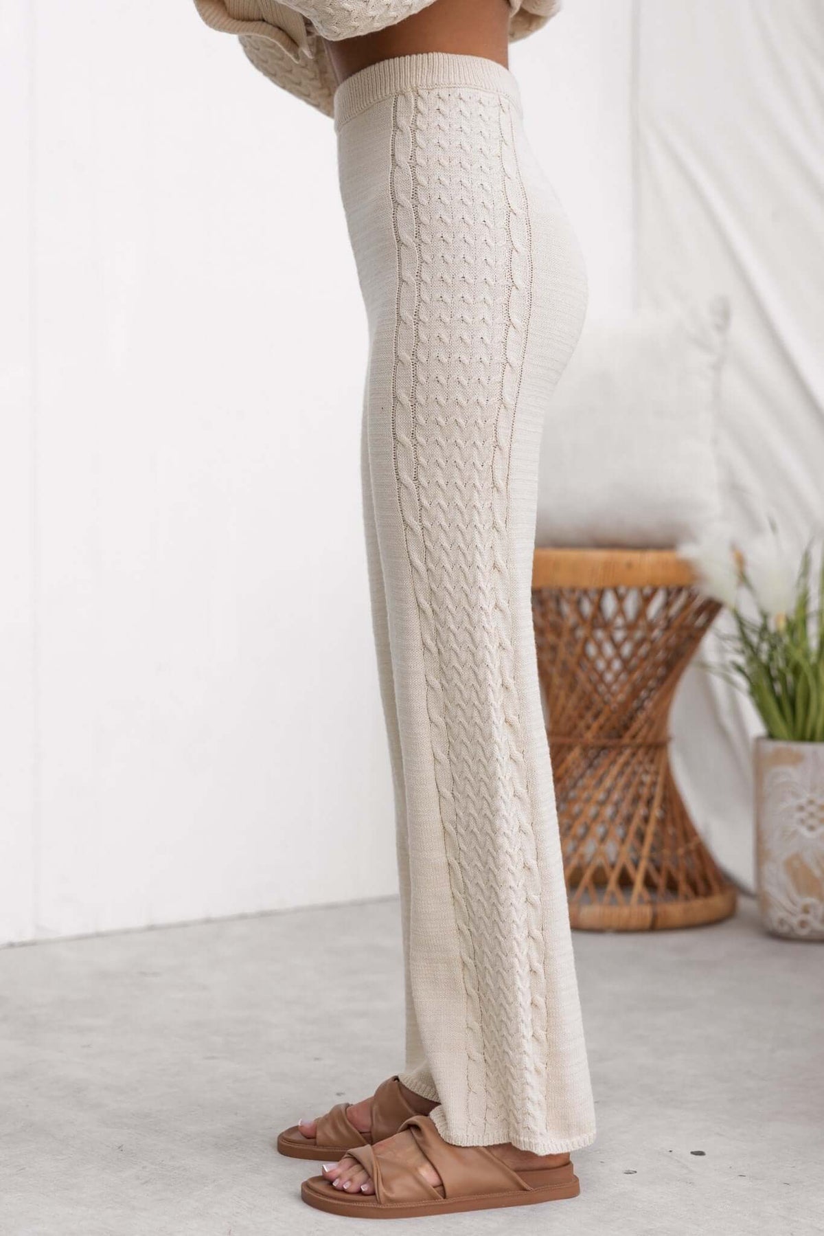 Side view of Jesse Pants featuring drop crotch style, high waist, and cable knit design in a soft beige color.