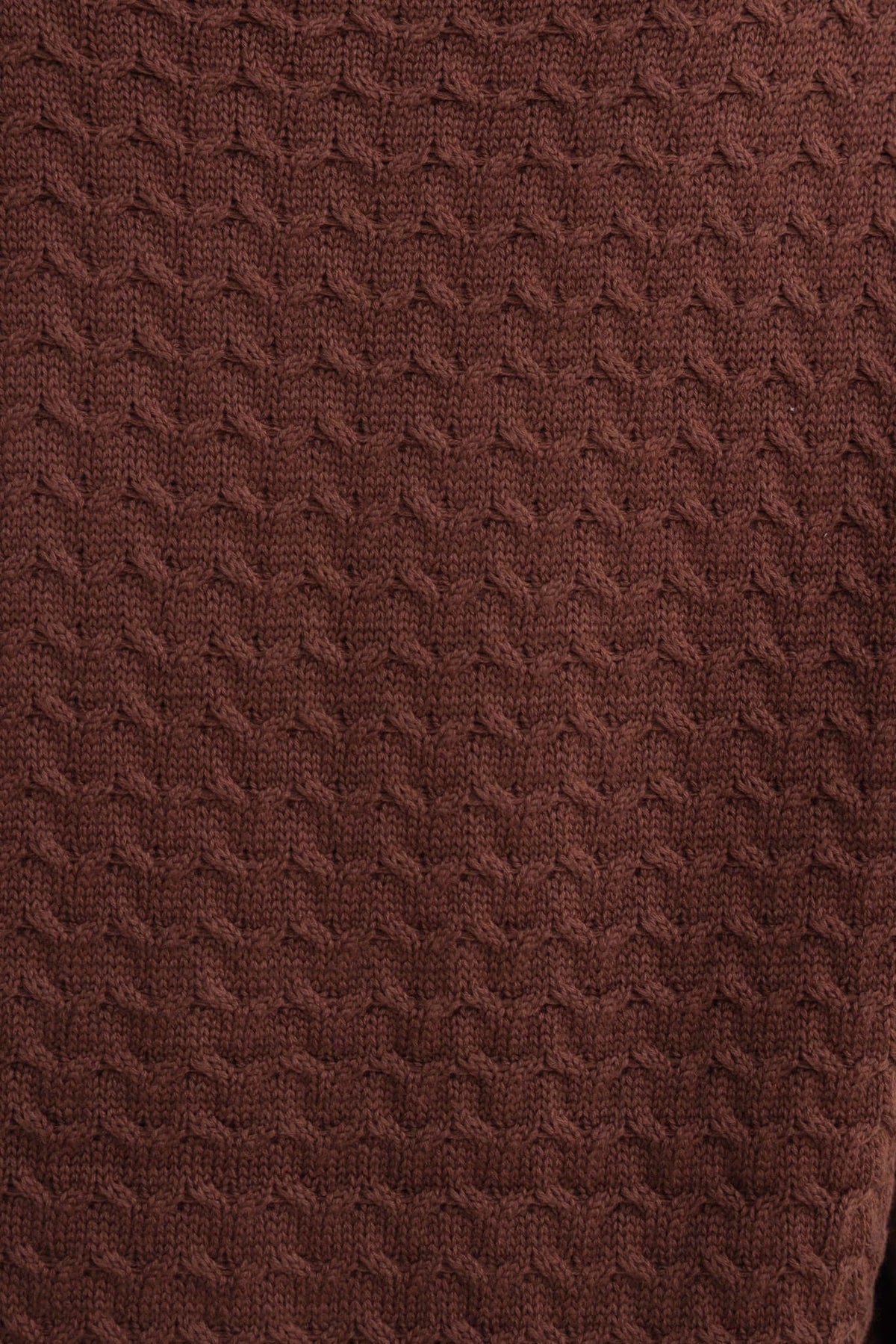 Textured brown knit fabric of the Jesse Cardigan with a cable knit design, showcasing its cozy appearance.