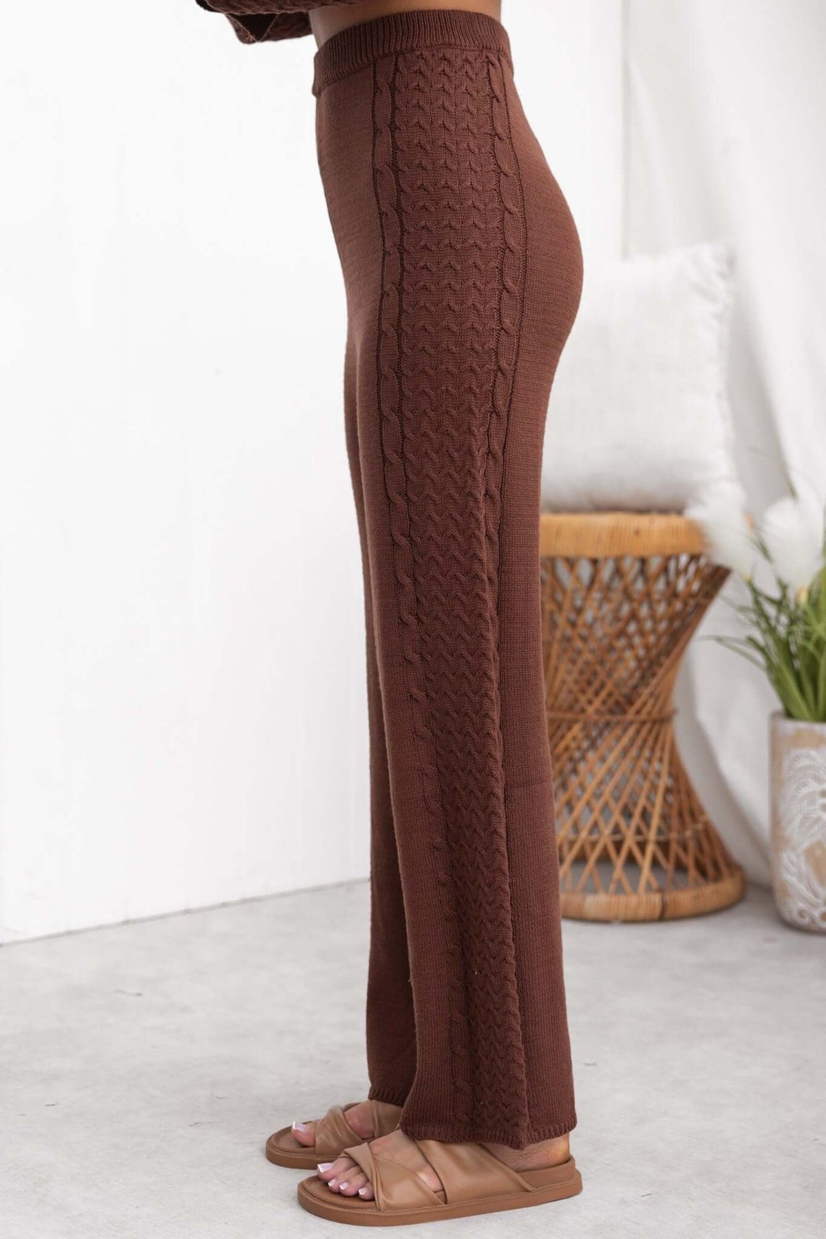 Side view of brown Jesse Pants featuring a drop crotch style, mid-high waist, and cable knit design.