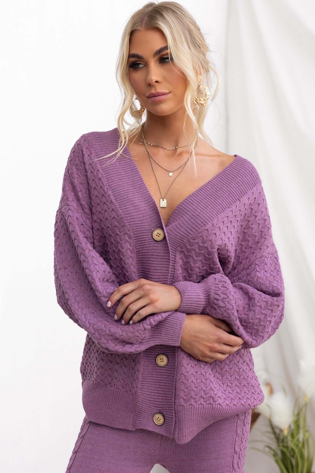Jesse Cardigan in soft purple with V-neckline and button-up front, styled with relaxed fit and knit material.