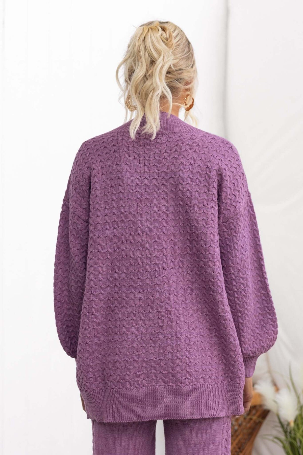 Back view of a cozy purple Jesse Cardigan featuring a relaxed fit and textured knit design.