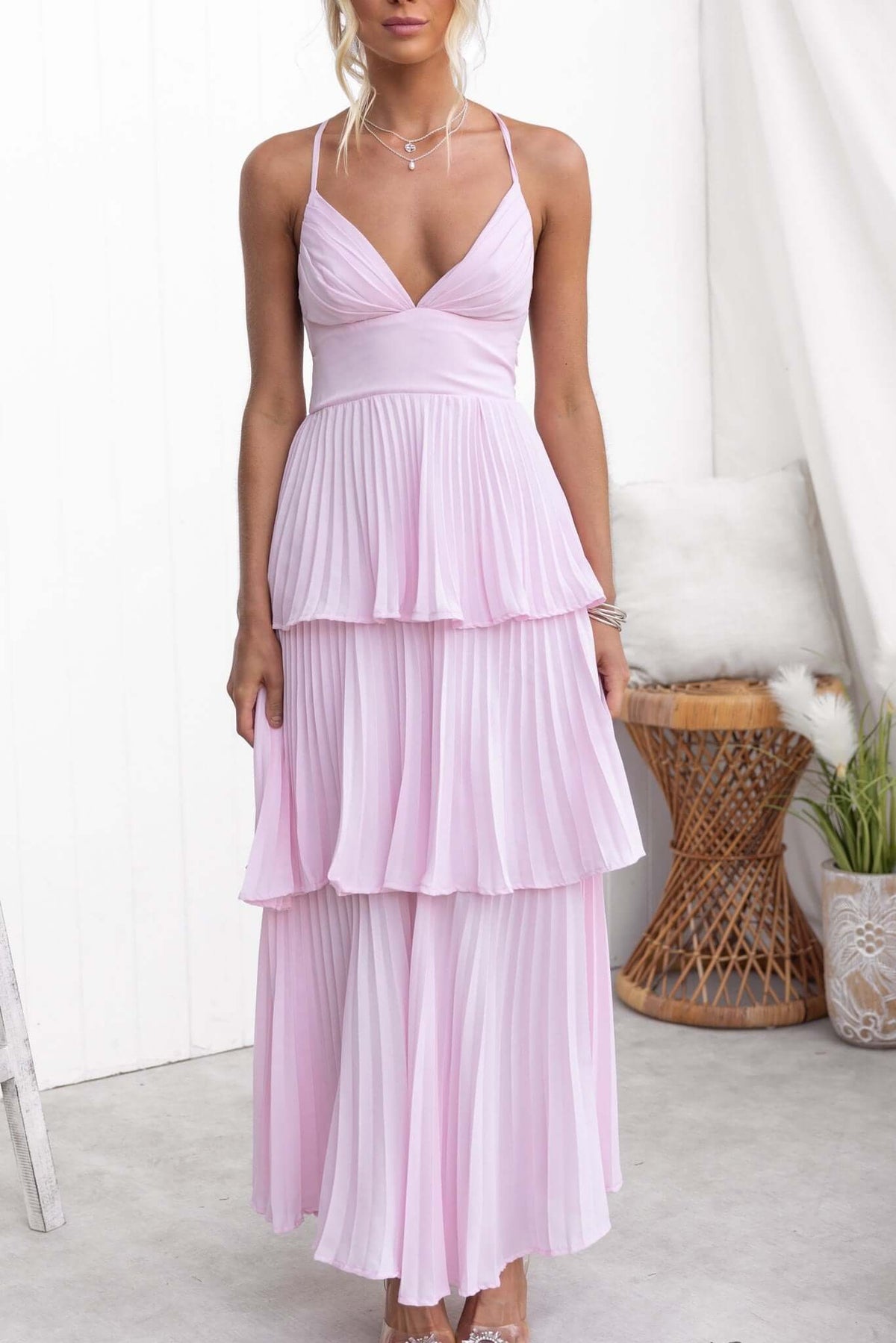 Remmy Maxi Dress in soft pink with tie straps and pleated ruffle skirt, perfect for elegant occasions.