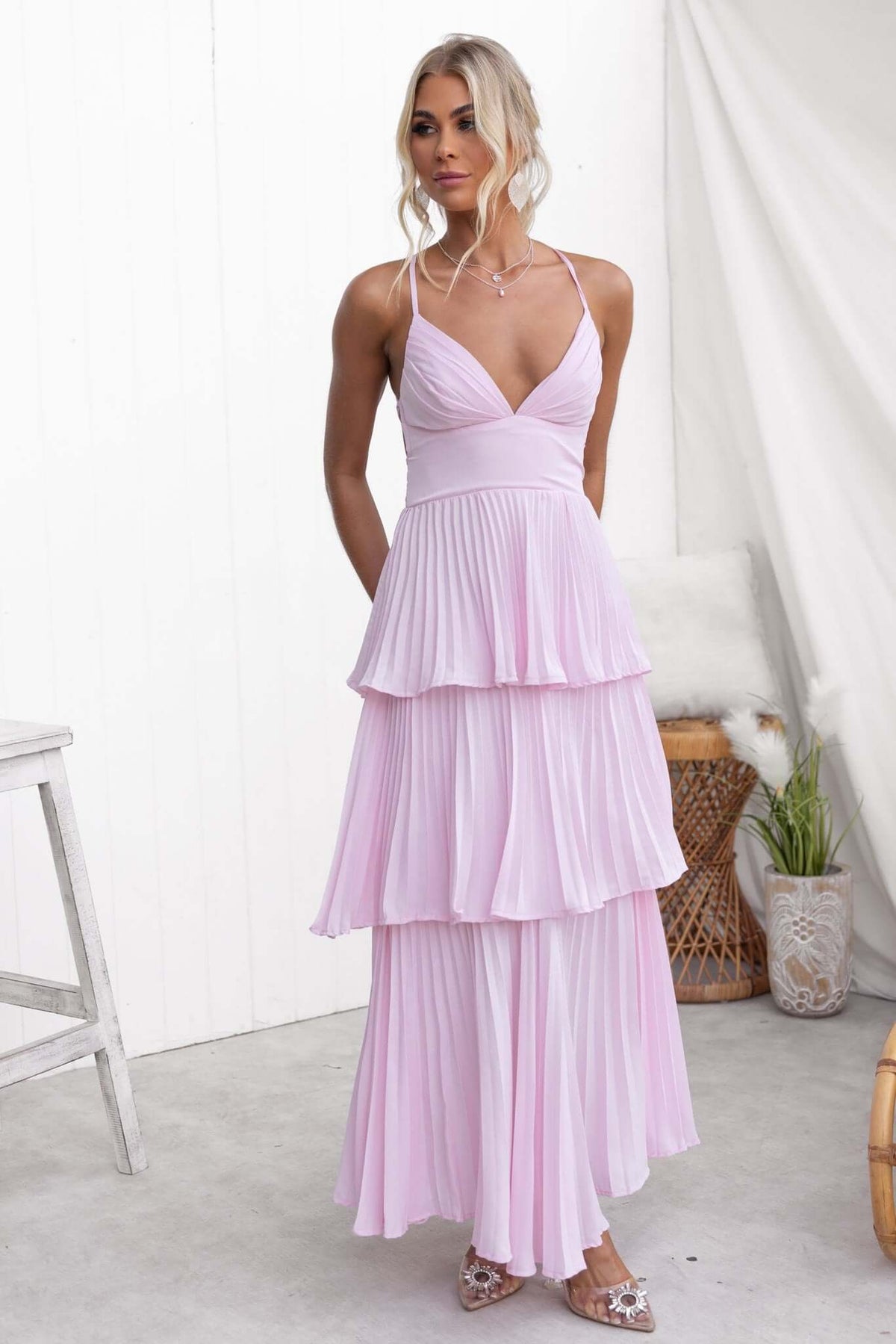 Elegant Remmy Maxi Dress with tie straps and pleated ruffle skirt in soft pink, perfect for special occasions.