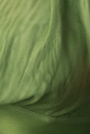 Close-up of soft green mesh fabric, showcasing the texture of the Larne Maxi Dress.