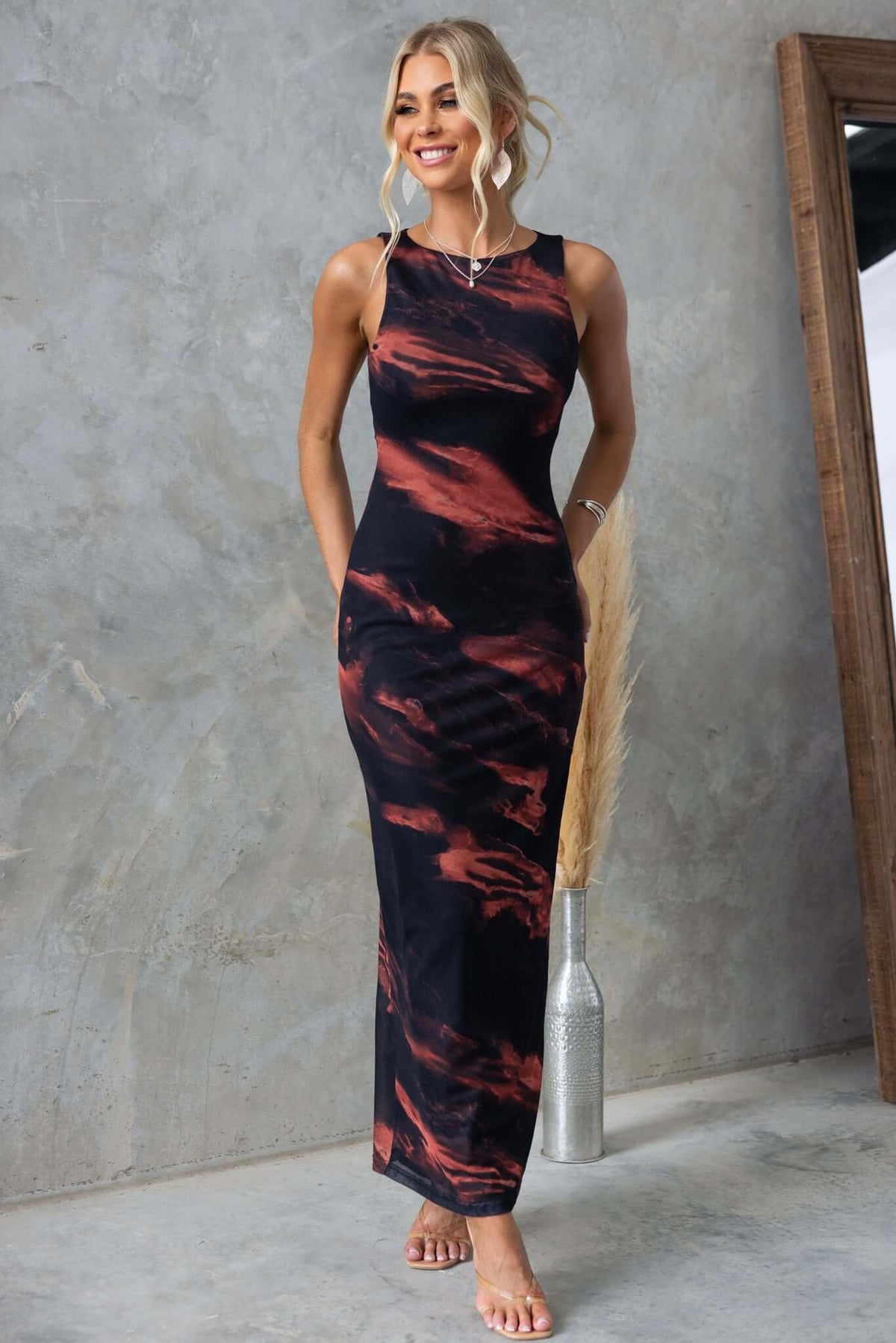 Black and rust maxi dress with high neckline and stretchy mesh material, styled for a casual look.