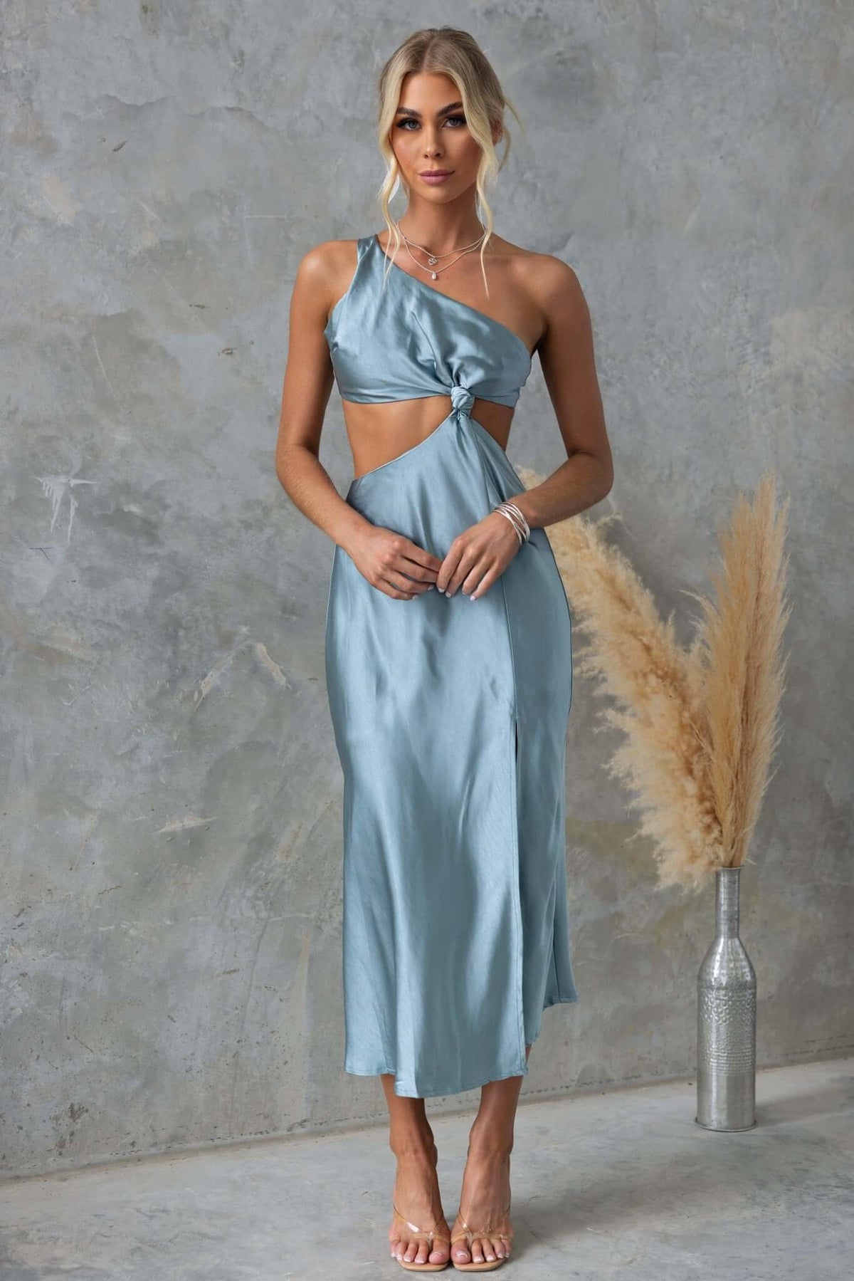 Model wearing Own It Midi Dress in blue, featuring a one-shoulder neckline and cut-out design with tie straps.